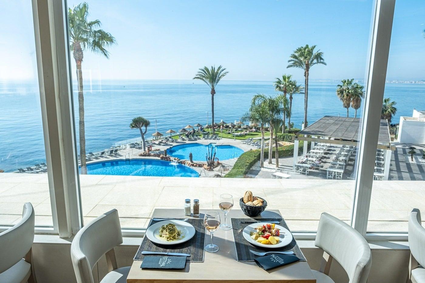 Dining room views of the coast and outdoor swimming pool at Hotel Estival Torrequebrada