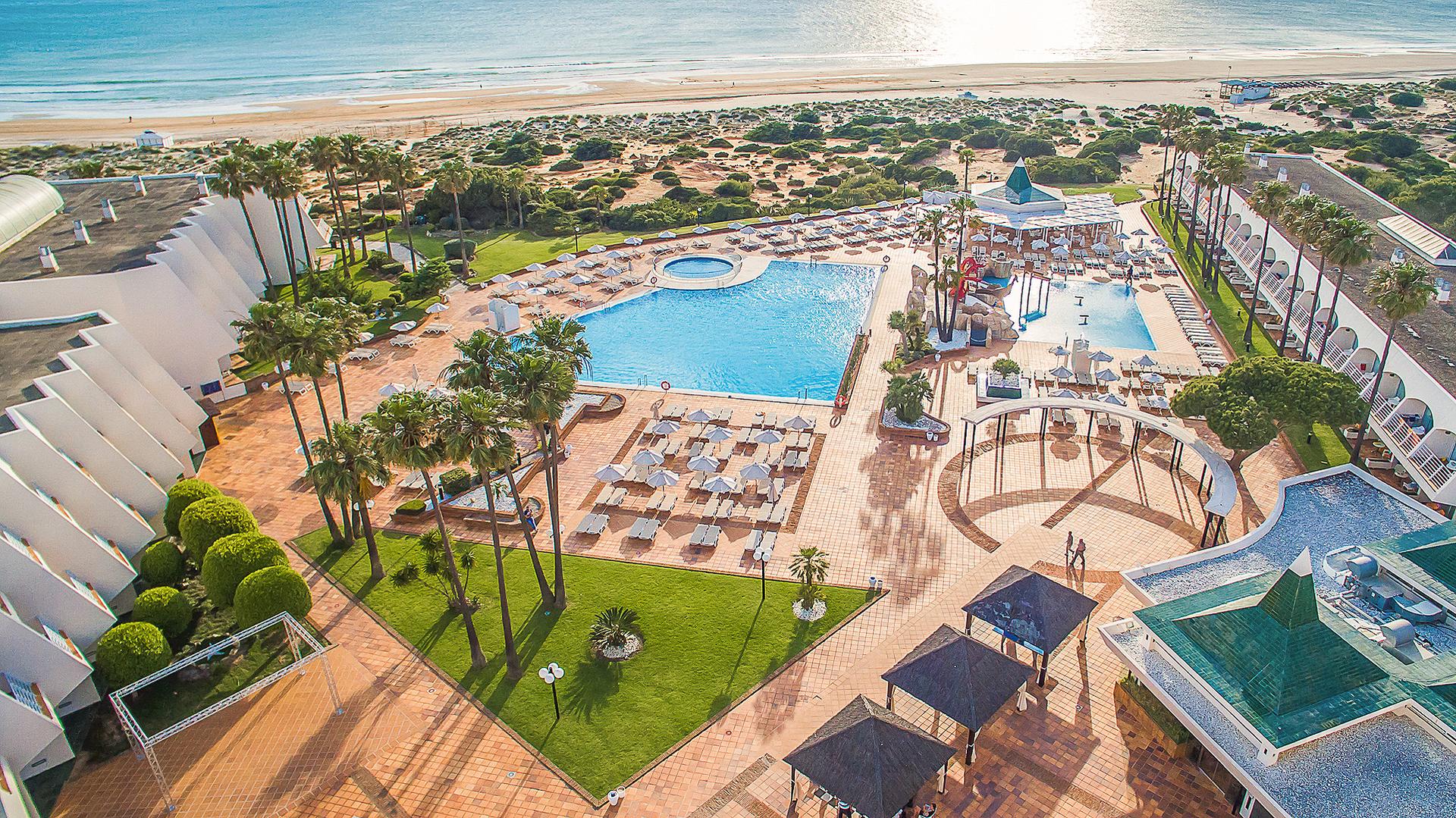 Aerial view of the outdor pool rea with the beach in the background