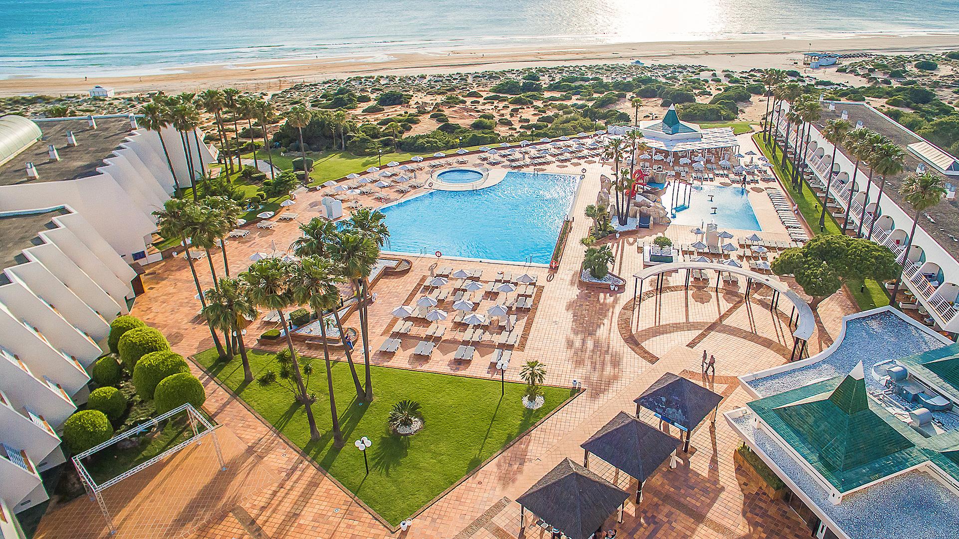 Aerial view of the outdor pool rea with the beach in the background