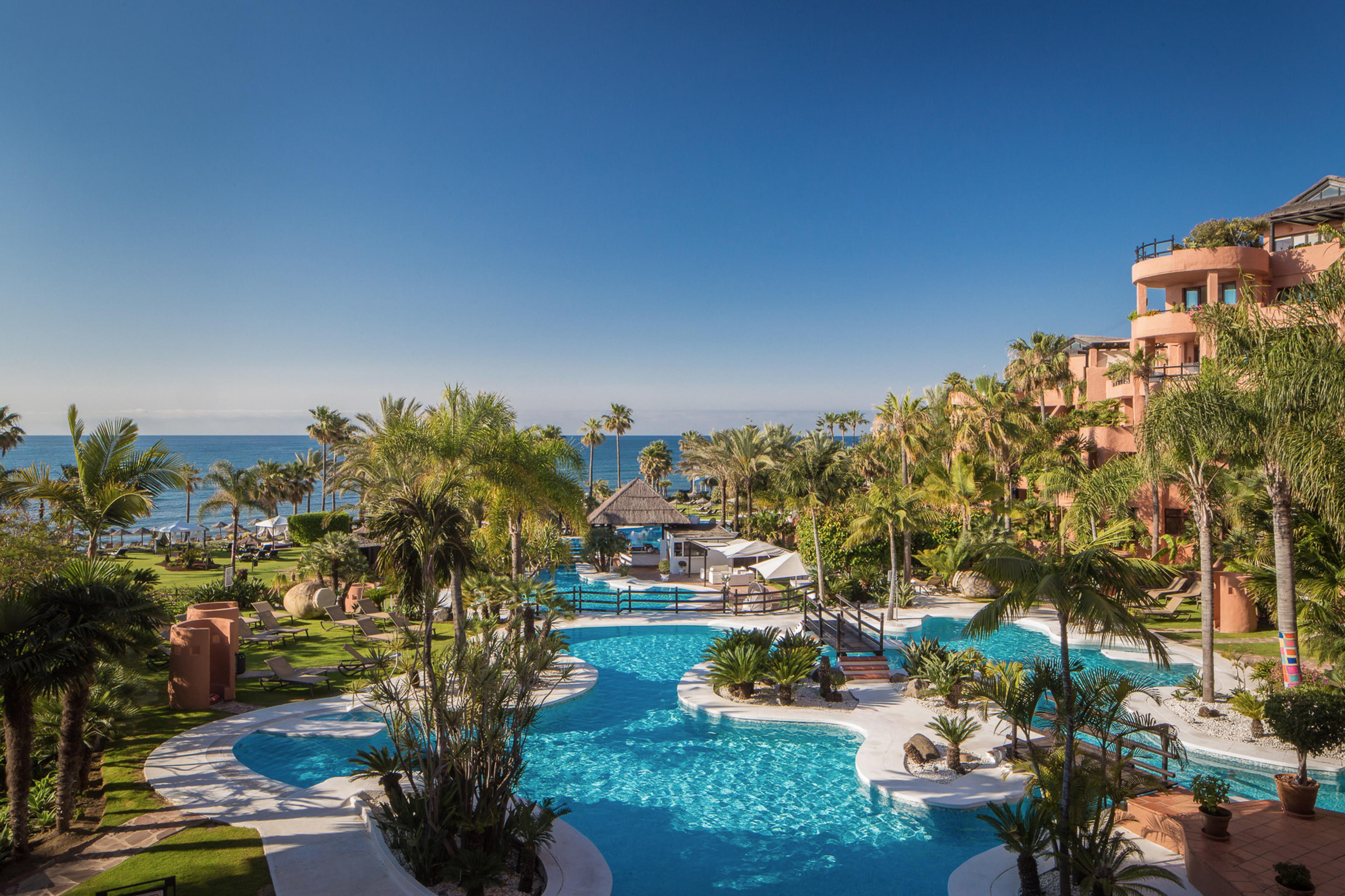 Overhead view of the outdoor swimming pool at Kempinski Hotel Bahia with coastal views