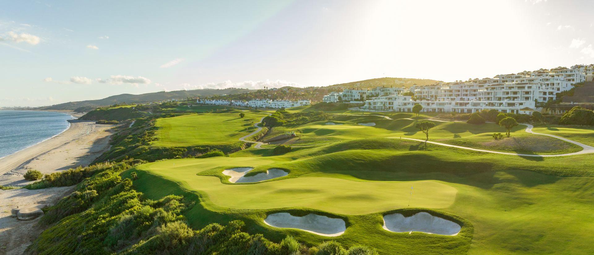A well maintained fairway leading to a smoot coastal green