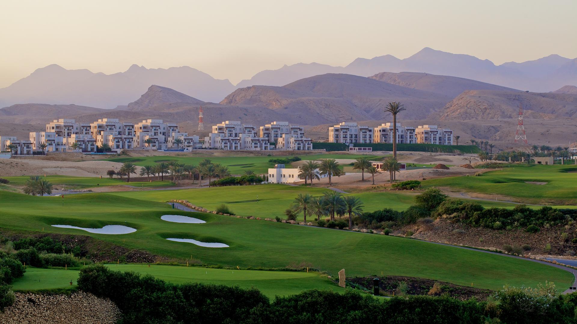 A well maintained fairway nestled with sand bunkers