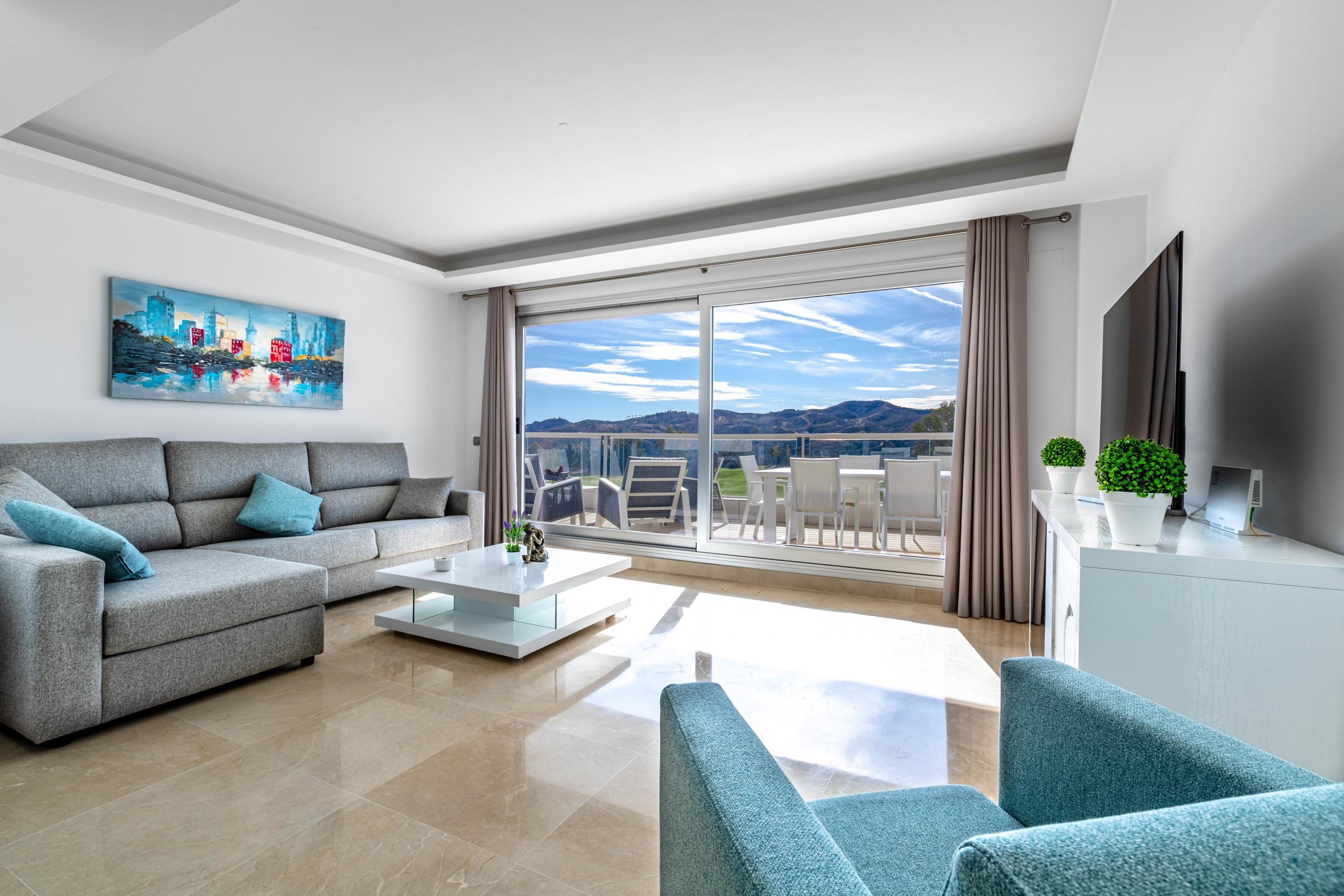 Living room with balcony views at La Cala Golf Resort - Rentals