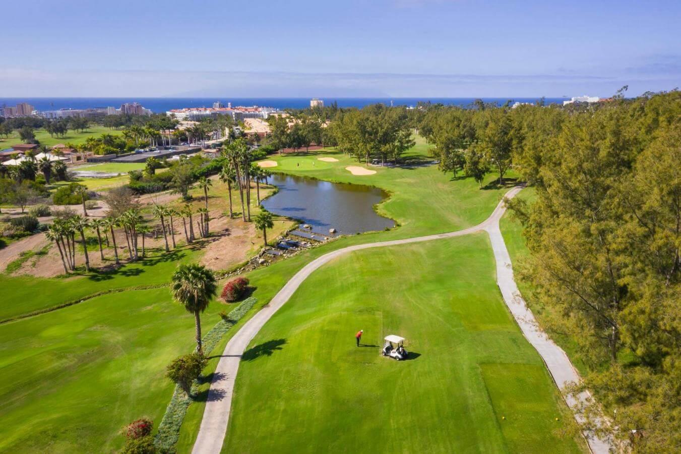 Overhead view of a well maintained fairway under clear blue skies