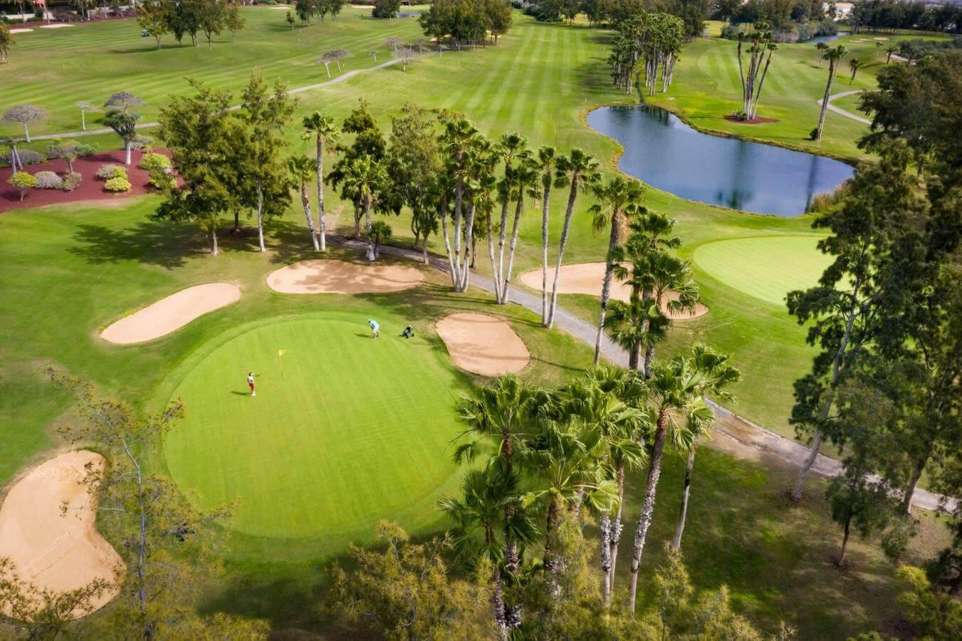 Overhead view of a smooth green surrounded by sand bunkers