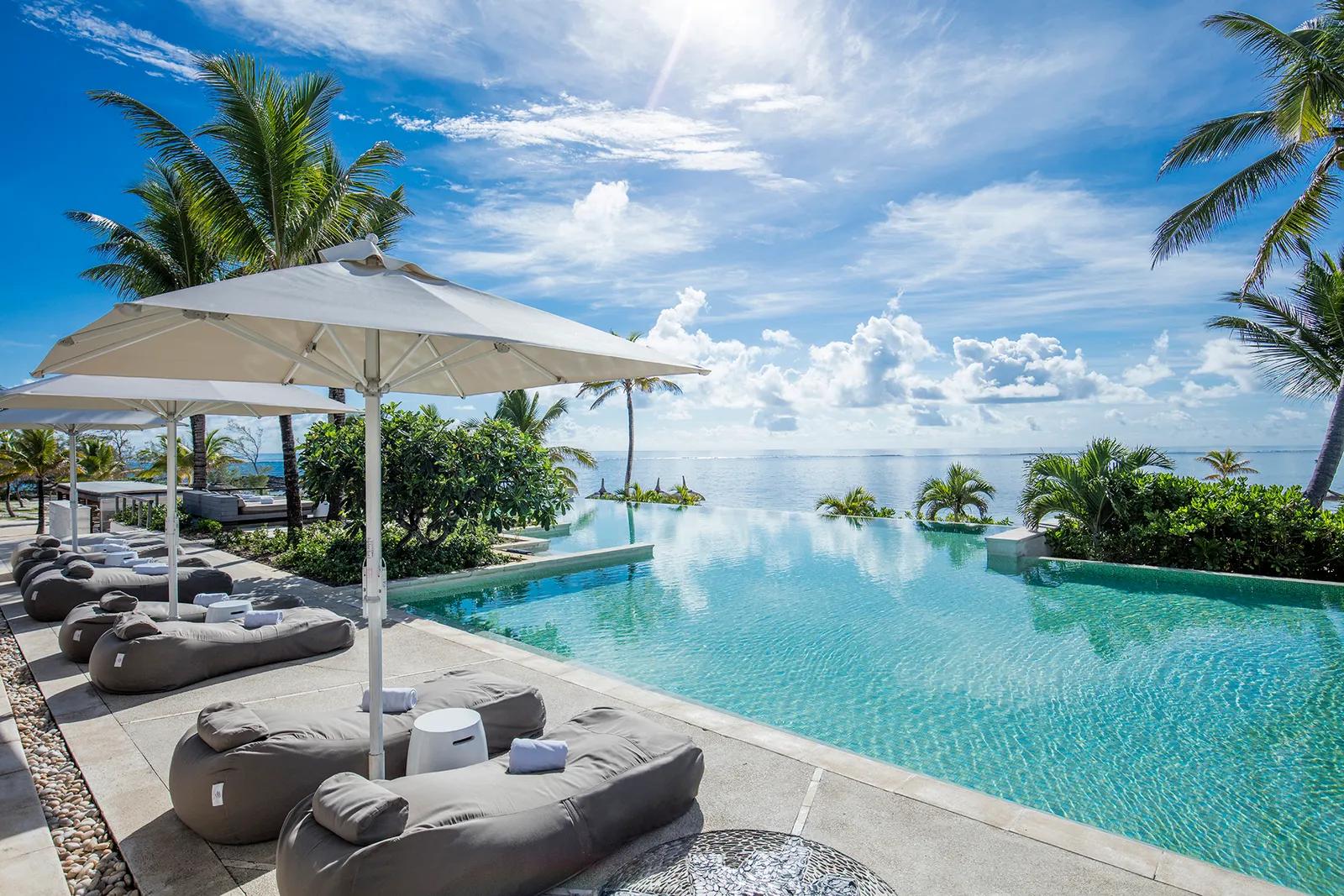 An outdoor swimming pool with sunbeds next to the pool