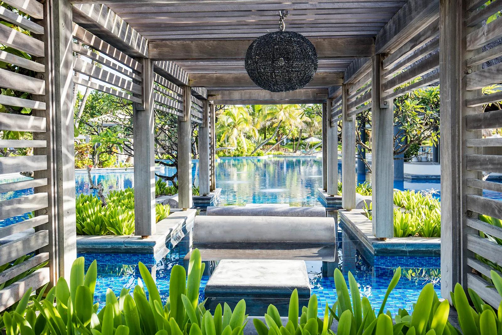 Cabanas next to the outdoor swimming pool at Long Beach Mauritius