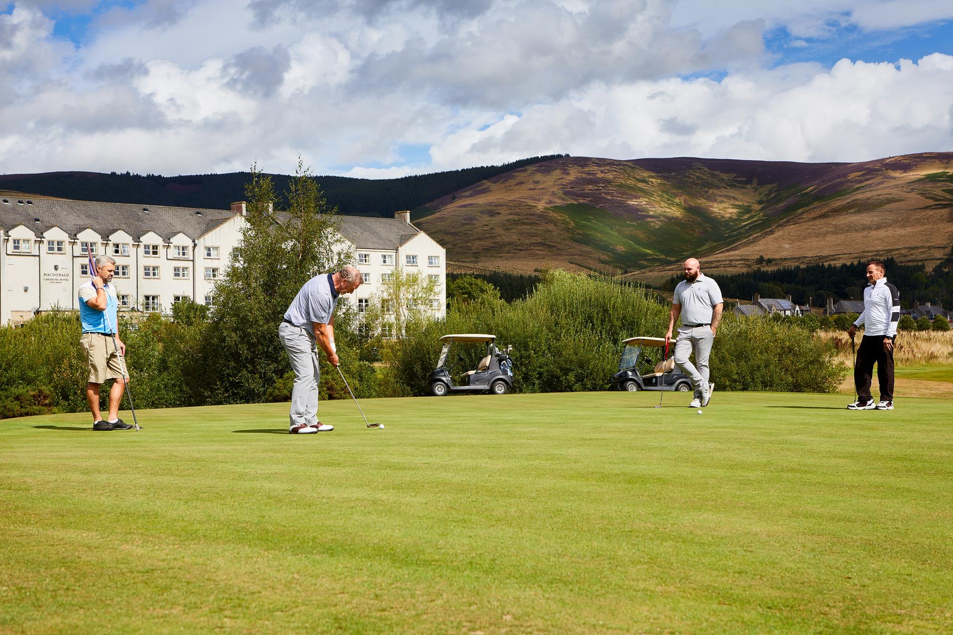 Golfers putting on a smooth green