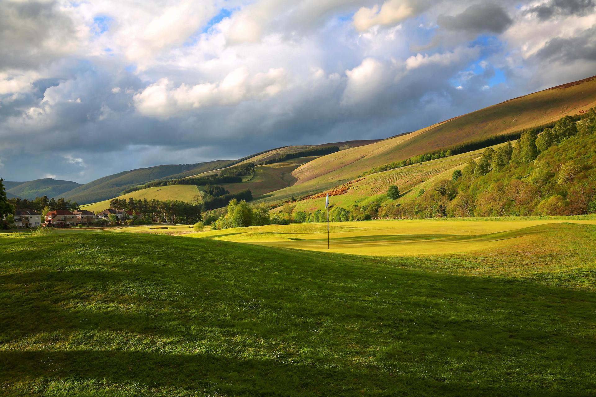 A well maintained fairway with distant mountain views