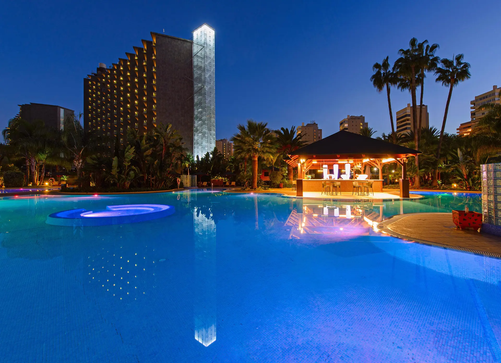 The Melia Sol Principe lit up at night overlooking the outdoor pool