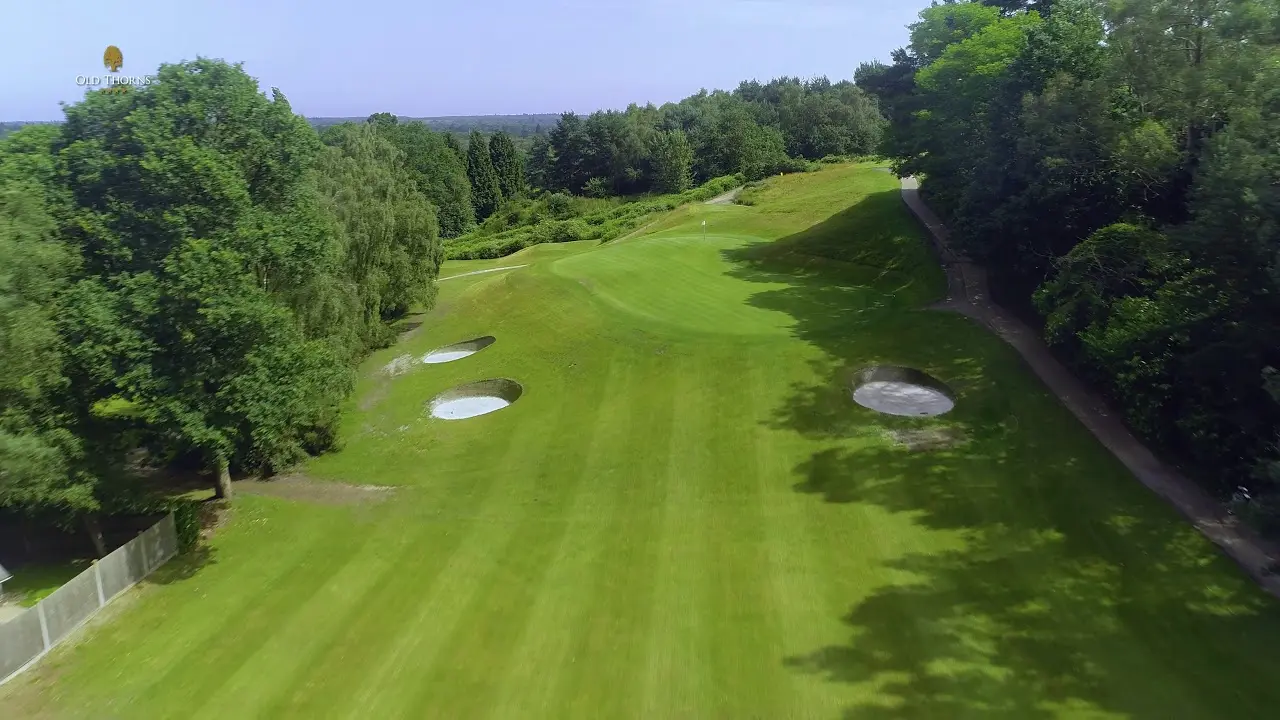 Narrow fairway leading to the green with a steep drop behind