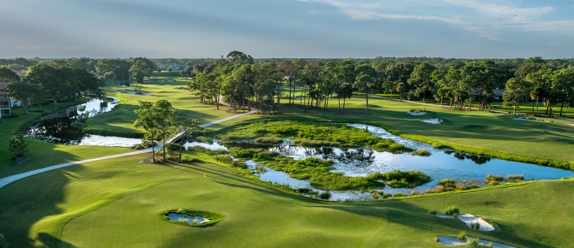 Overhead view of a well maintained fairway nestled with sand bunkers