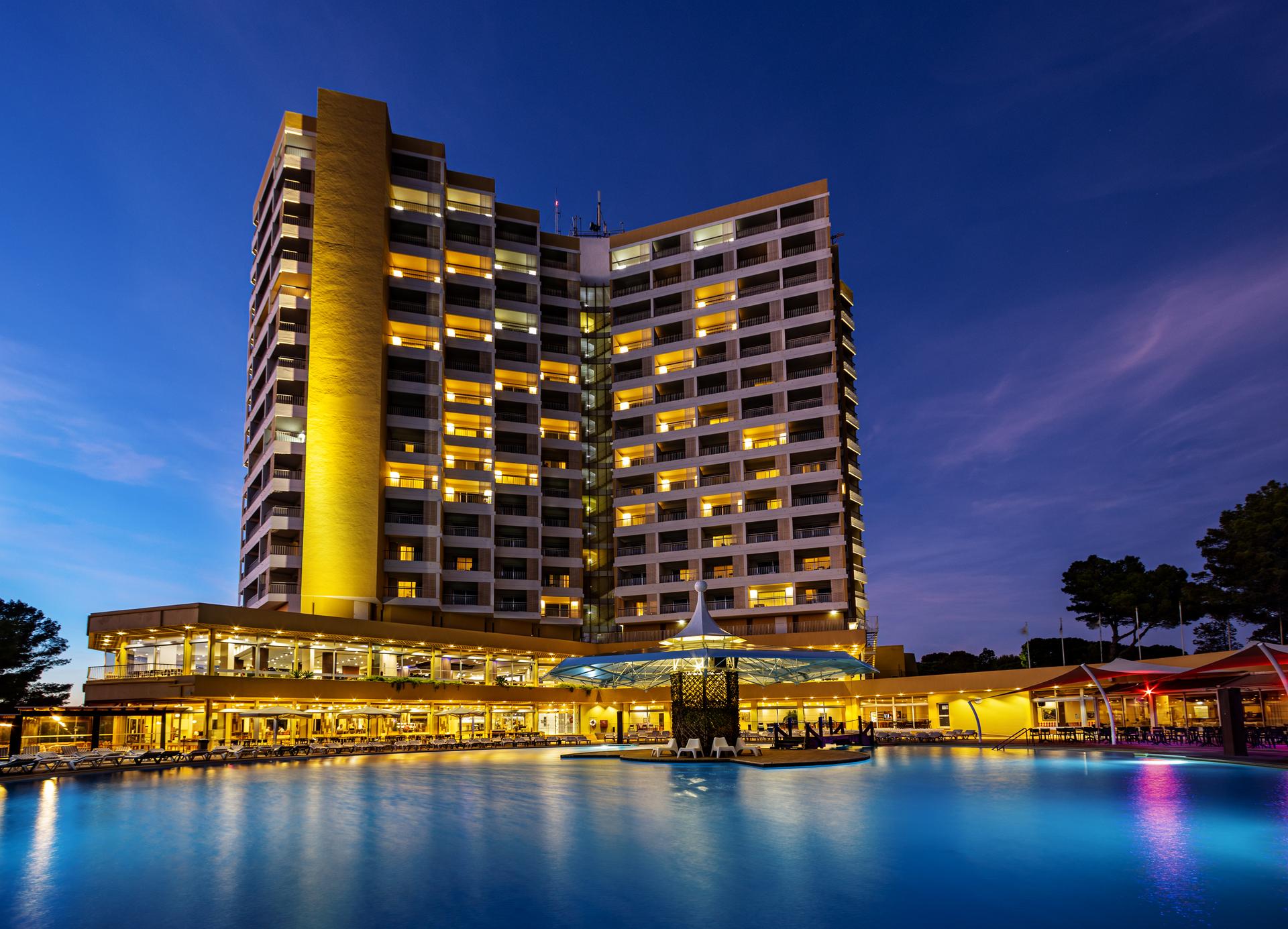 Panoramic view of the Pestana Blue Alvor Beach hotel lit up at evening