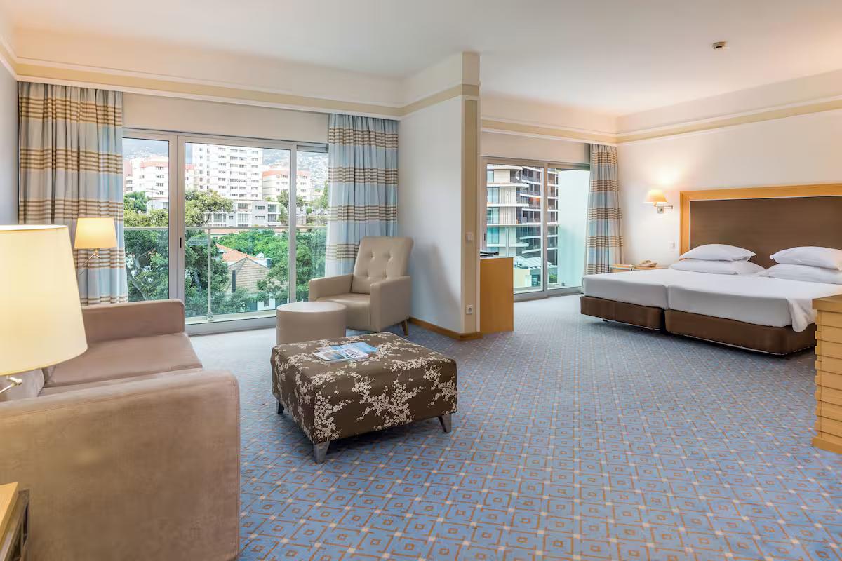 Double bed room with lounging area at the Pestana Carlton Madeira