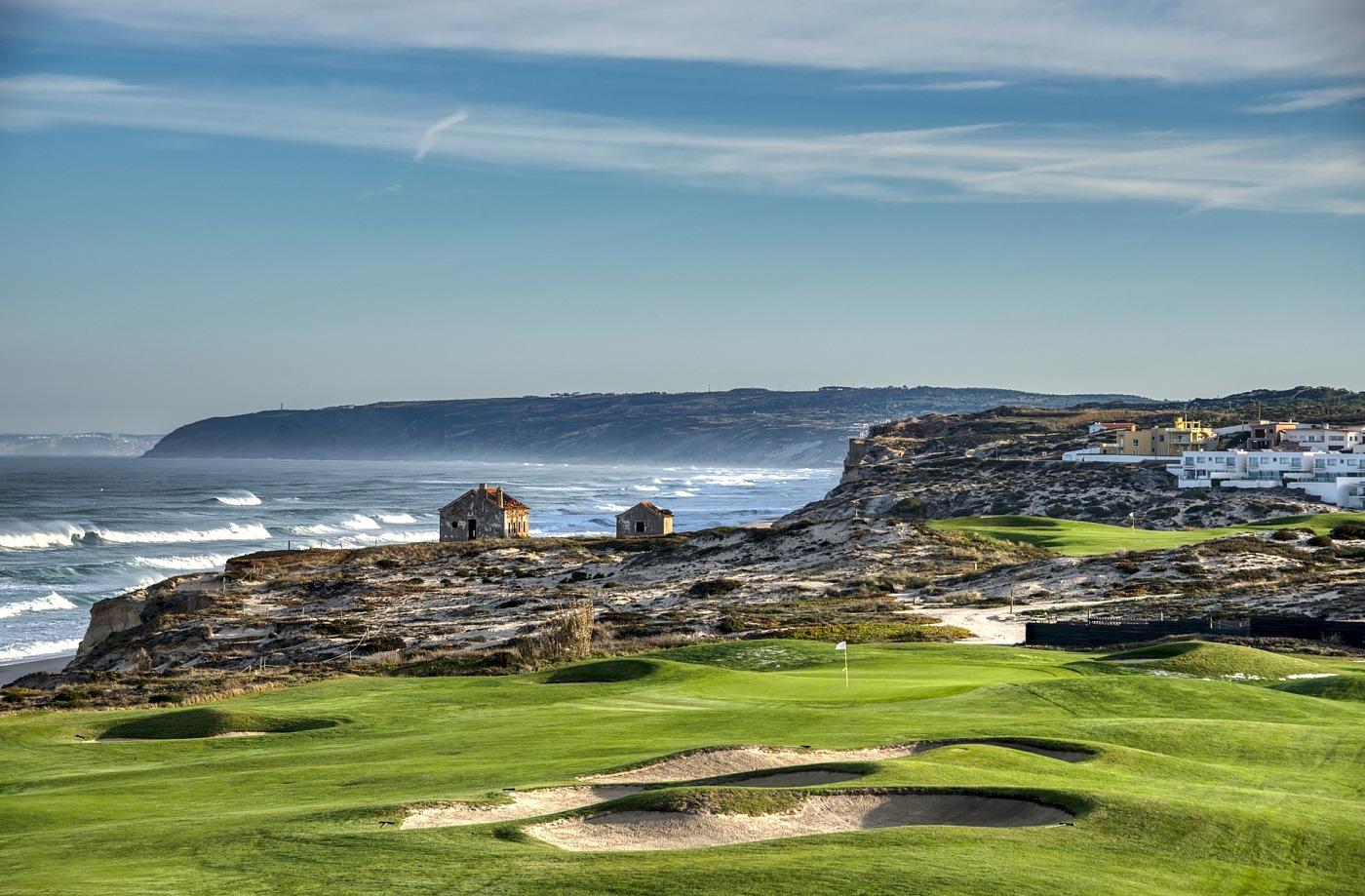 Panoramic view of a coastal green surrounded by sand bunkers