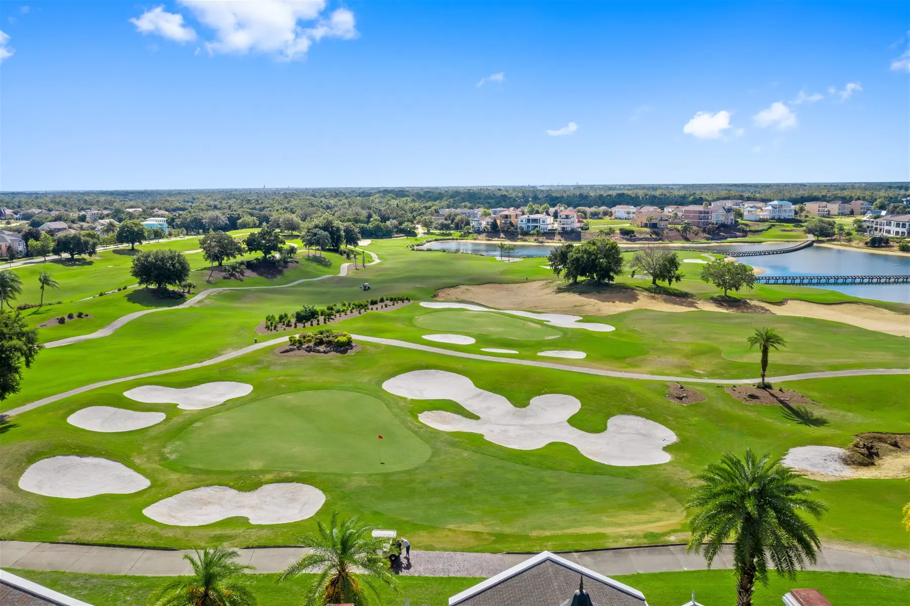 Panoramic view of a well maintained fairway riddled with sand bunkers