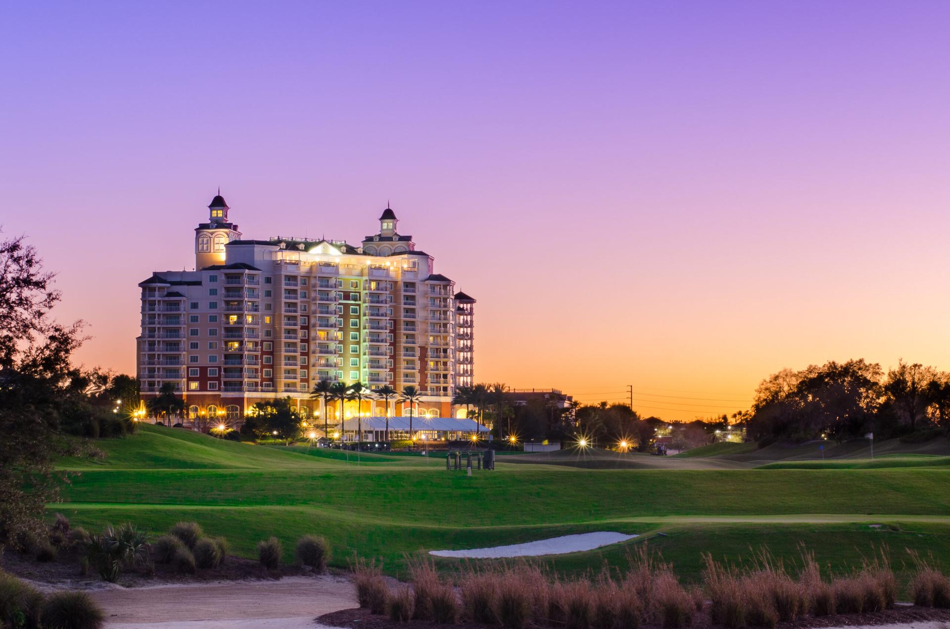 Panoramic view of the Reunion Resort with the sun setting behind the building