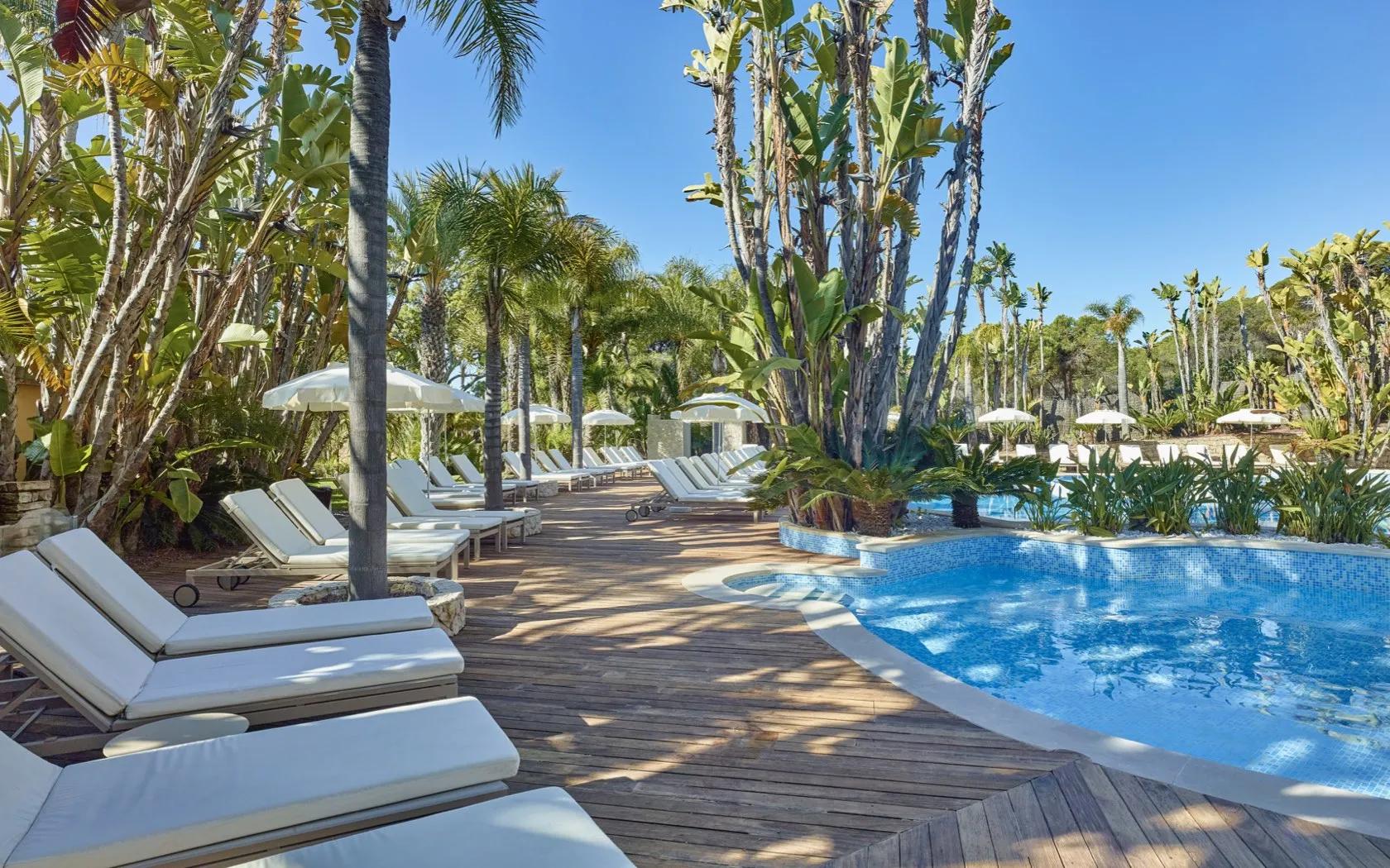 Sunbed lined outdoor pool at the Ria Park Garden Hotel