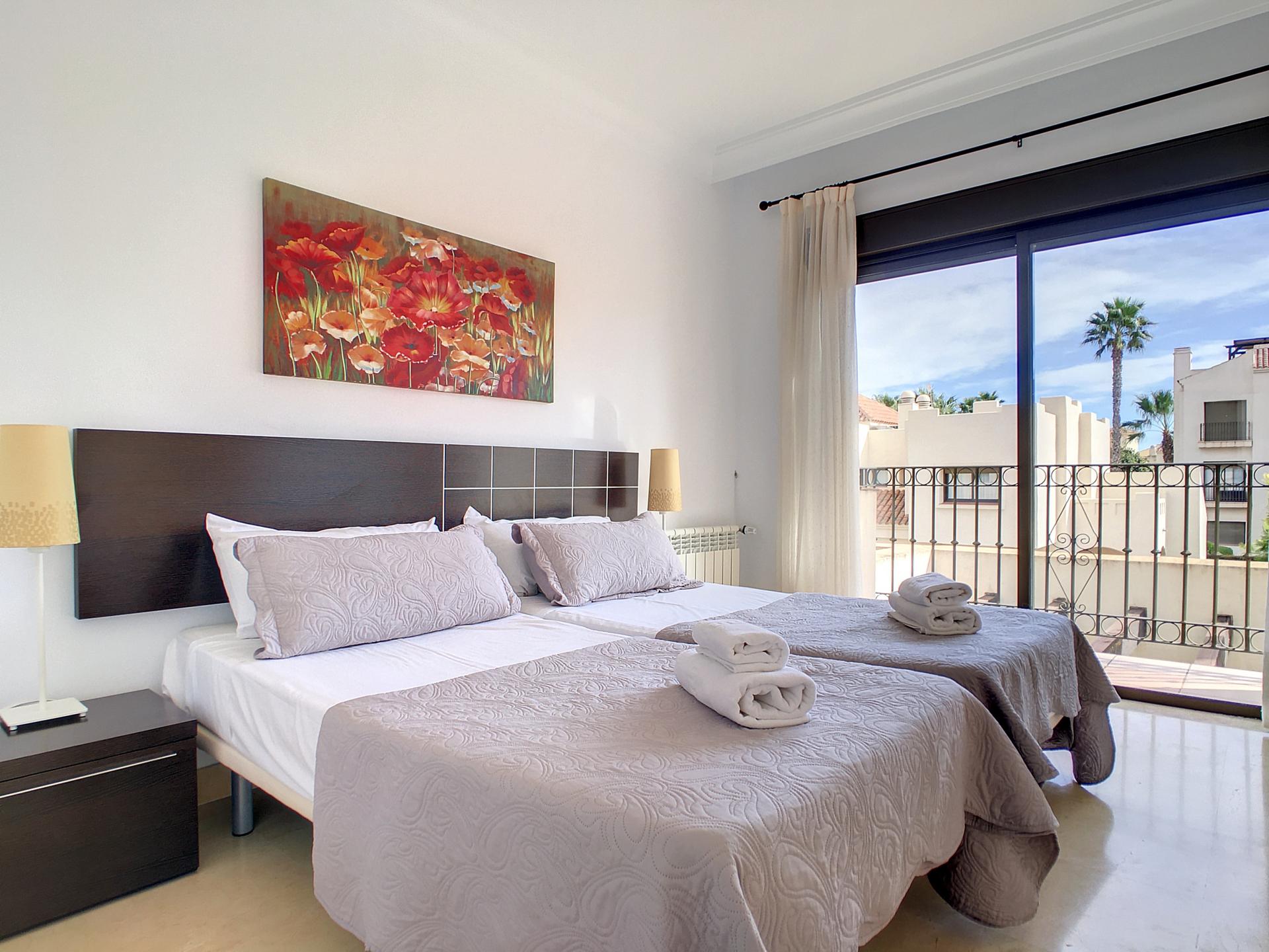 Twin bed room with balcony views at the Roda Golf & Beach Resort