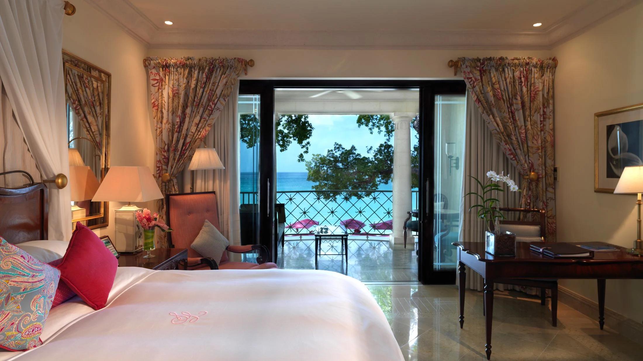 Panoramic view of a spacious double bed room with balcony views of the ocean