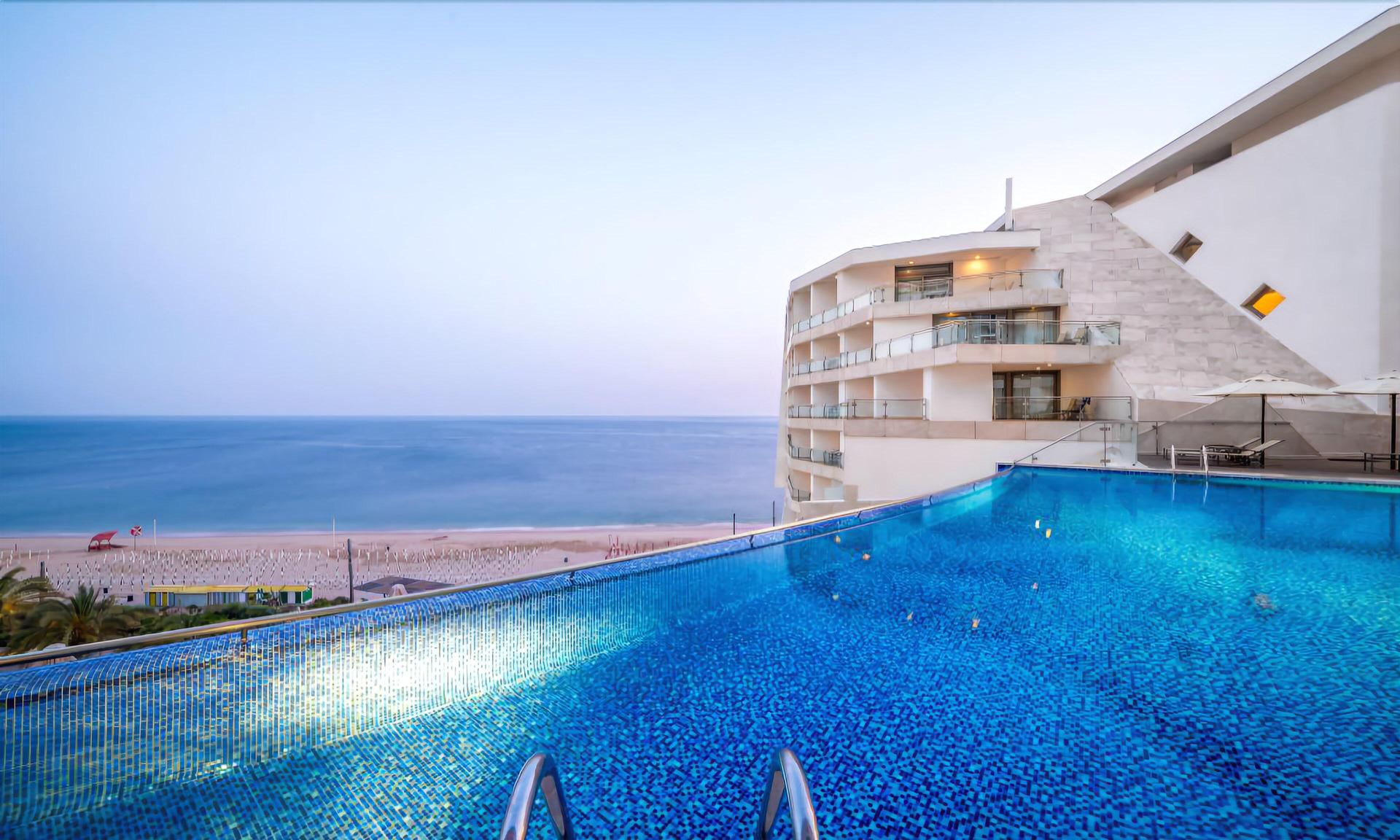 Outdoor swimming pool with views of the ocean at Sesimbra Oceanfront