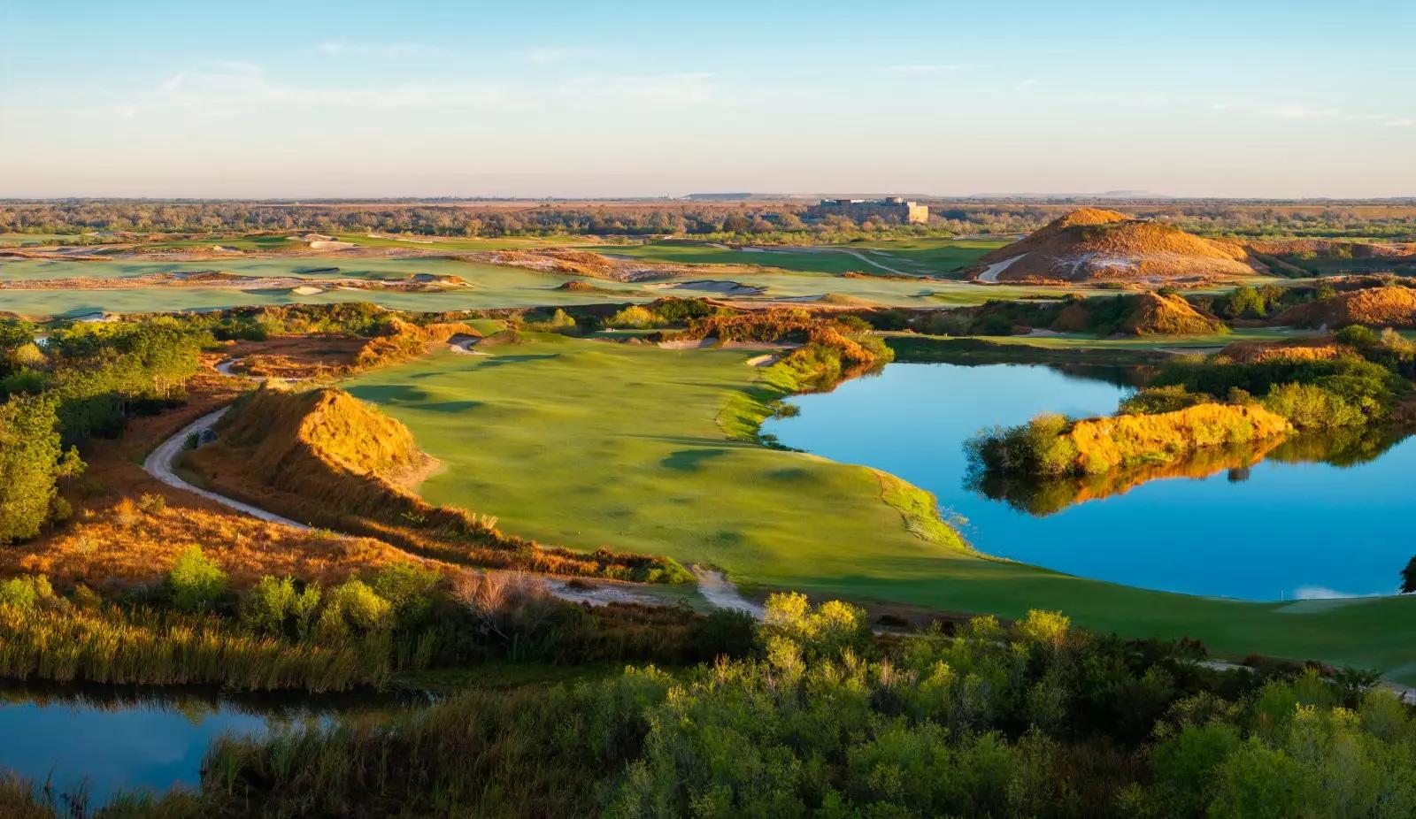 A well maintained fairway next to a water hazard