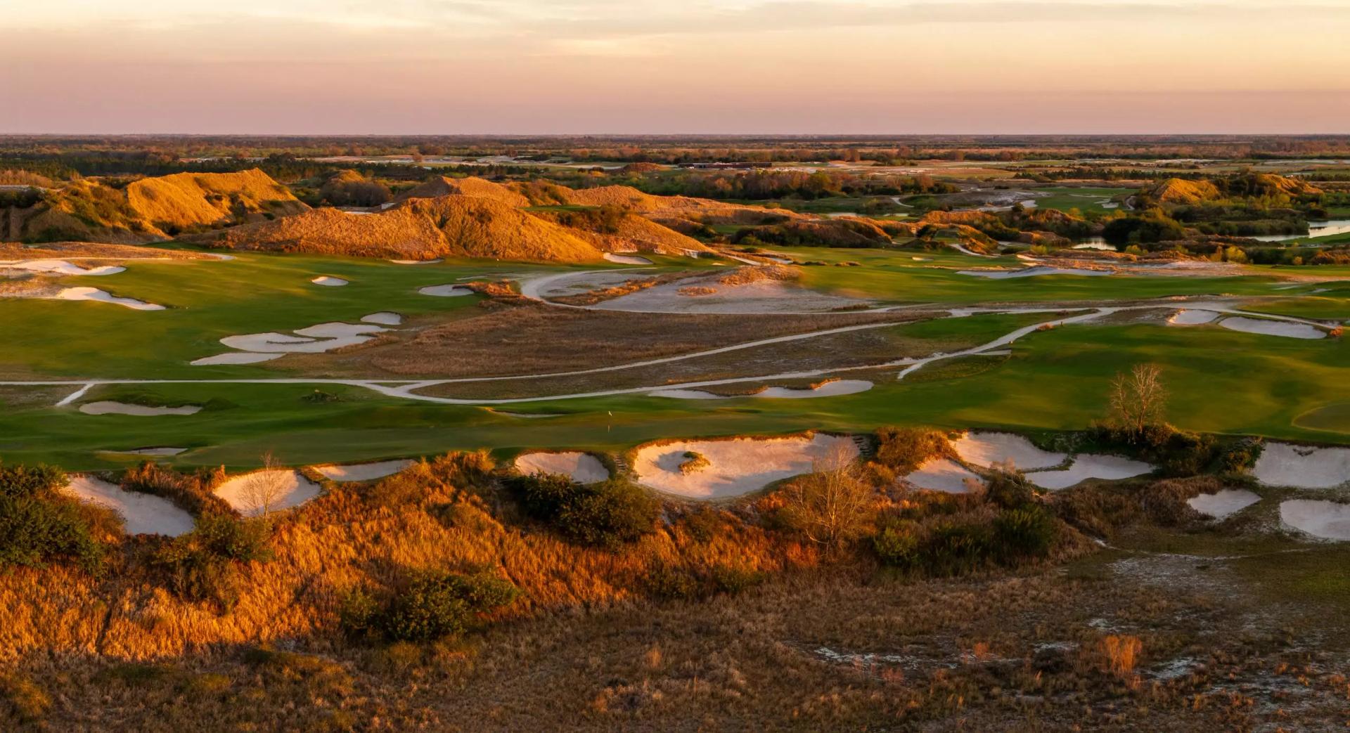 A well maintained fairway nestled with sand bunkers