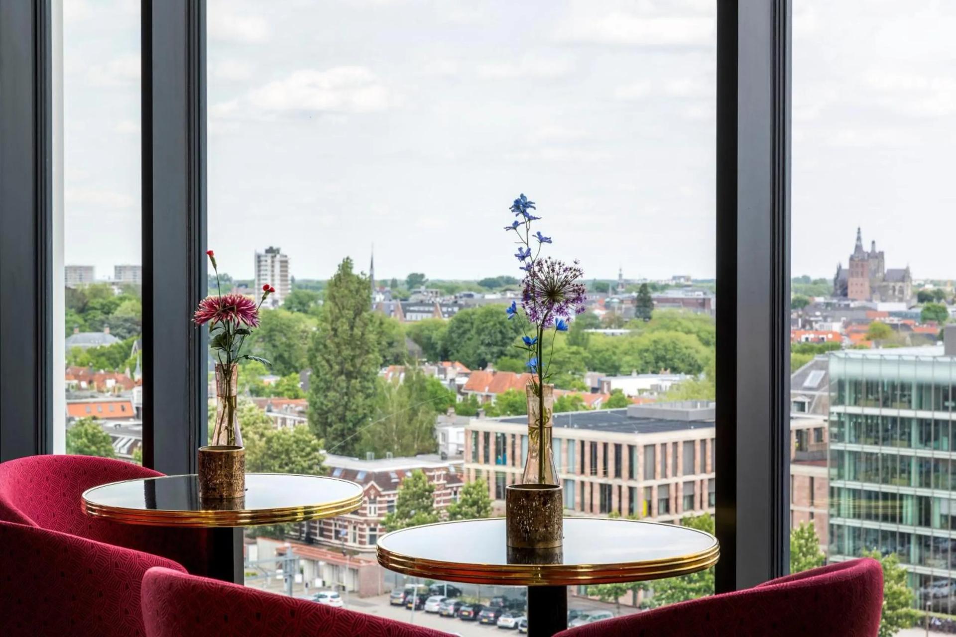 Dining area with views of the city at The Den, ‘s-Hertogenbosch, a Tribute Portfolio Hotel