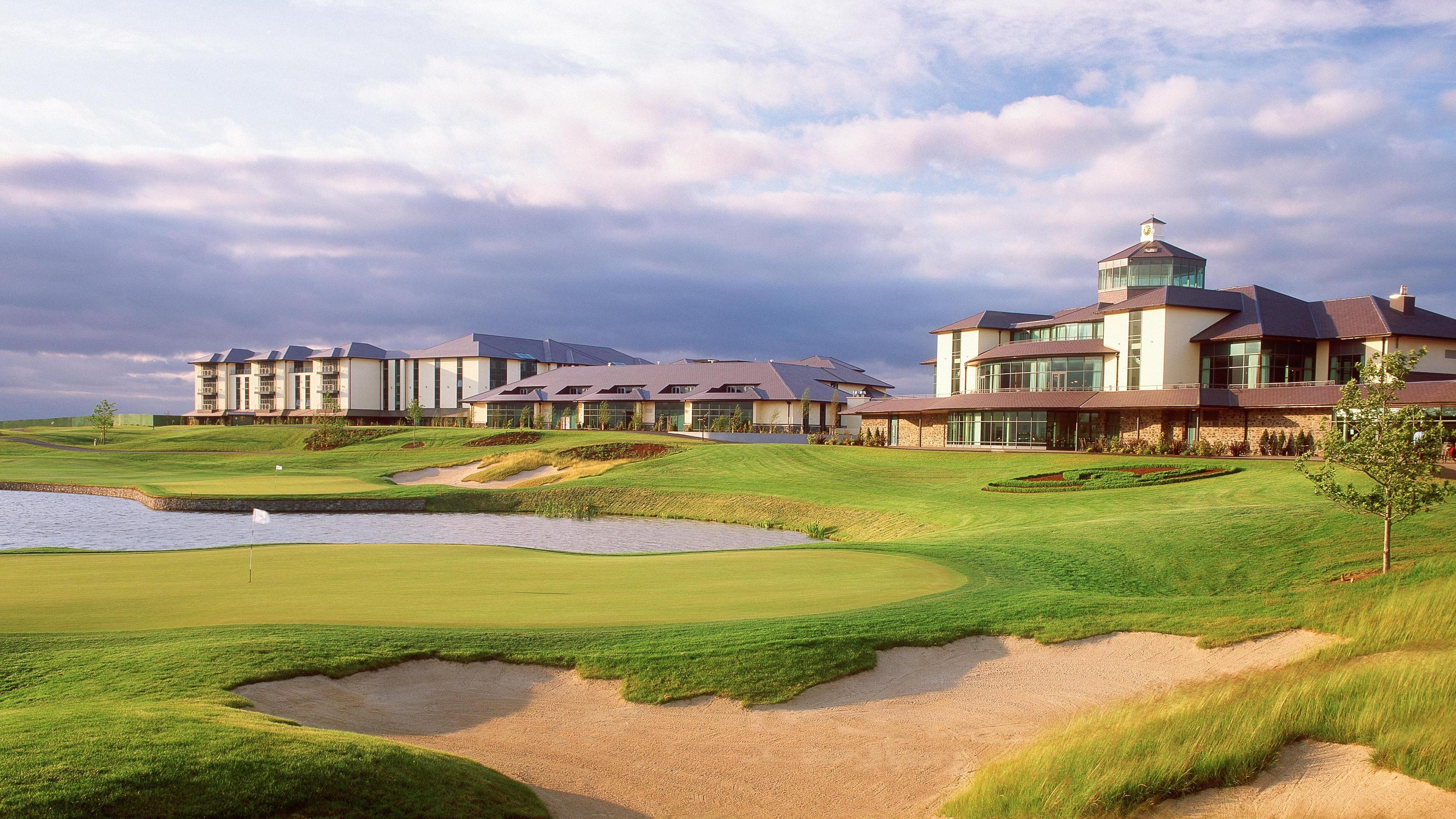 A well maintained fairway leading to a smooth green besides a sand bunker