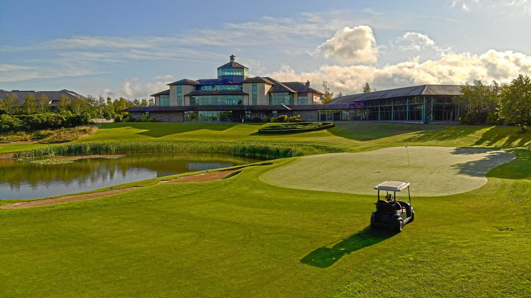 The Heritage Golf Resort building overlooking the course with a buggy driving on tghe