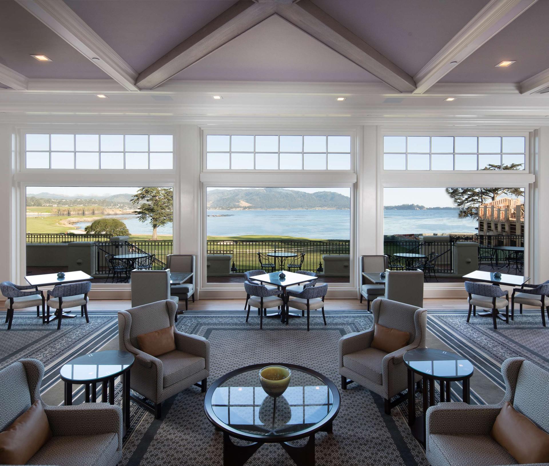 Indoor lounging area with views of the course at The Lodge at Pebble Beach