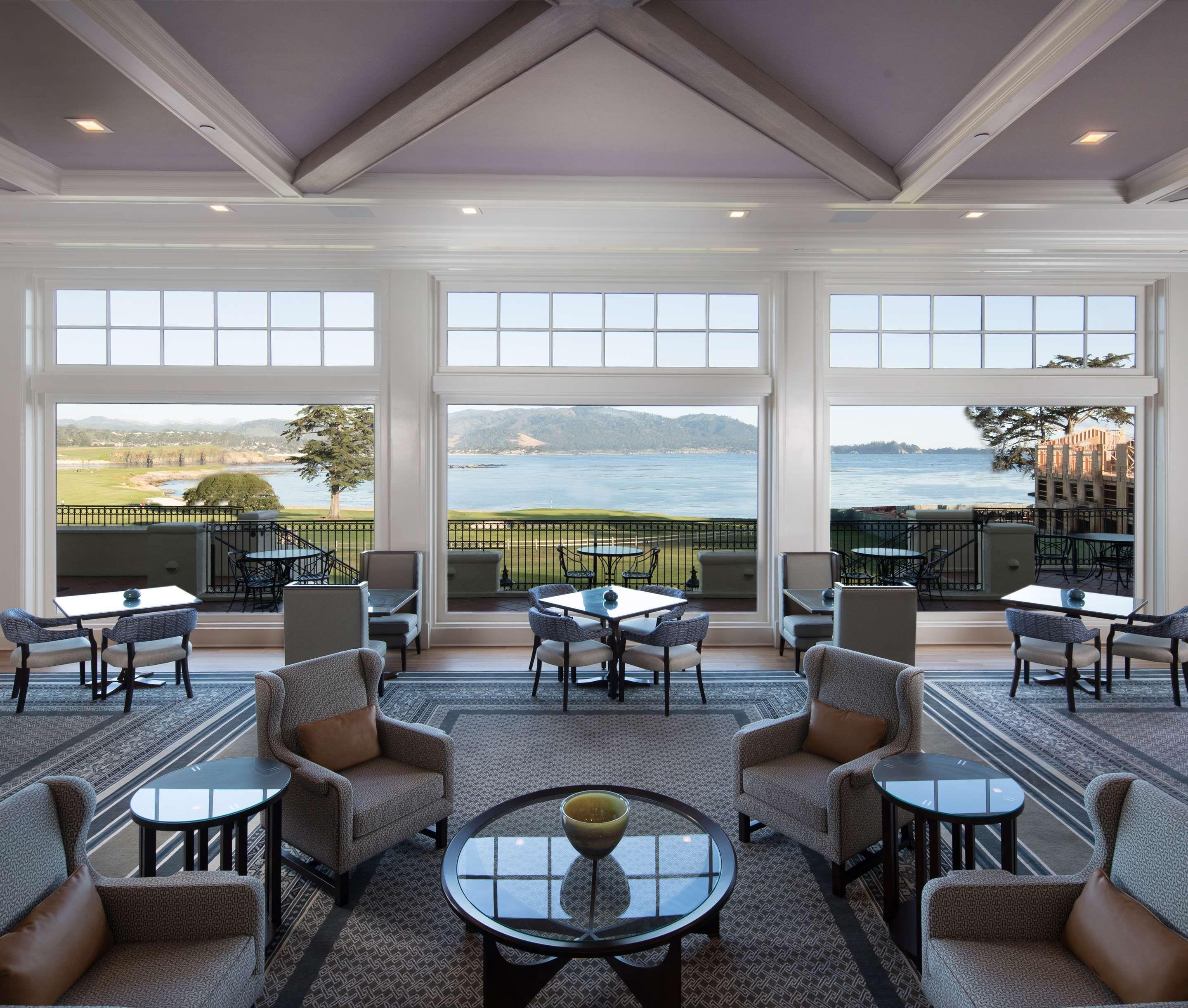 Indoor lounging area with views of the course at The Lodge at Pebble Beach