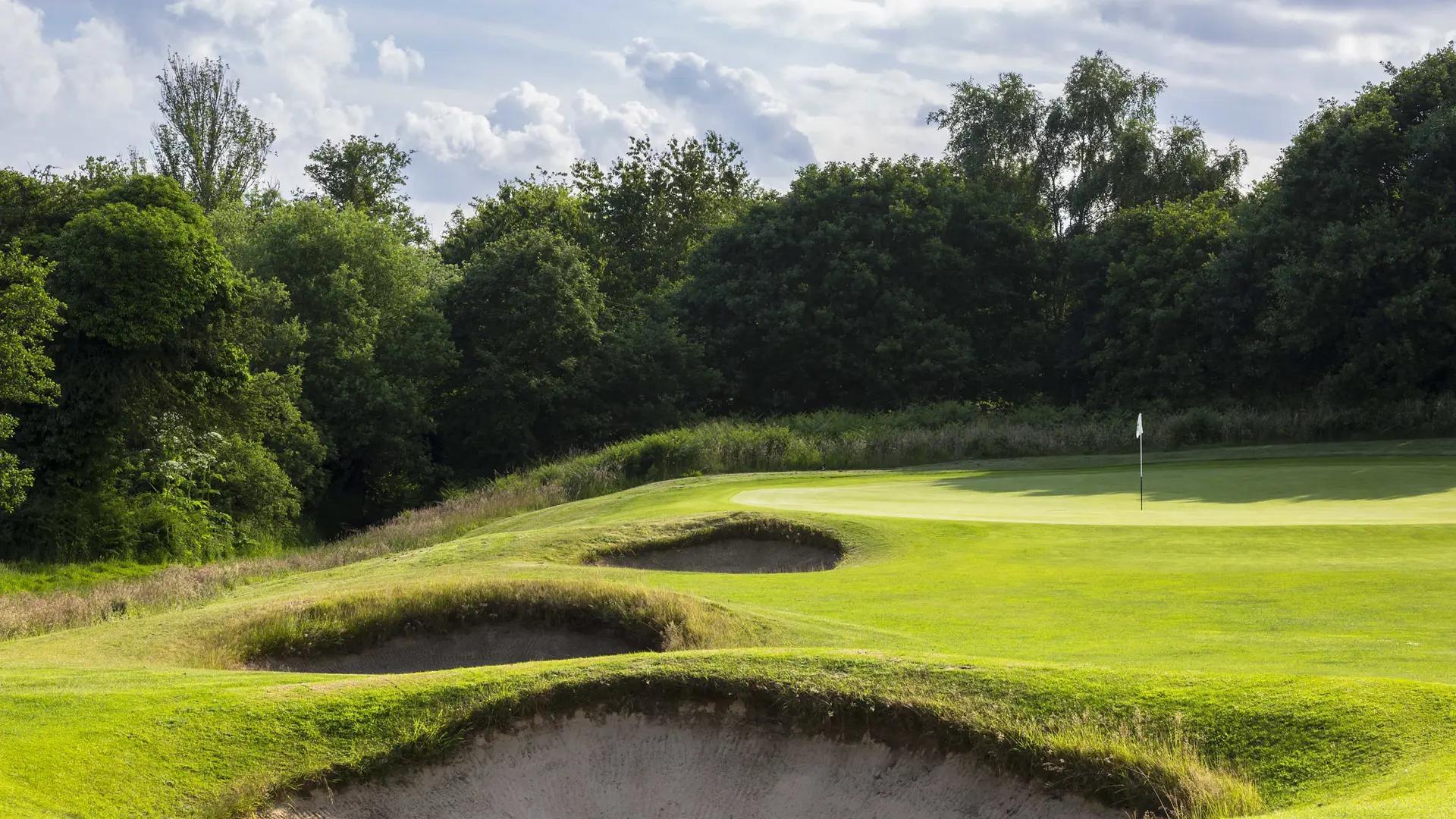 An elevated green surrounded by sand bunkers
