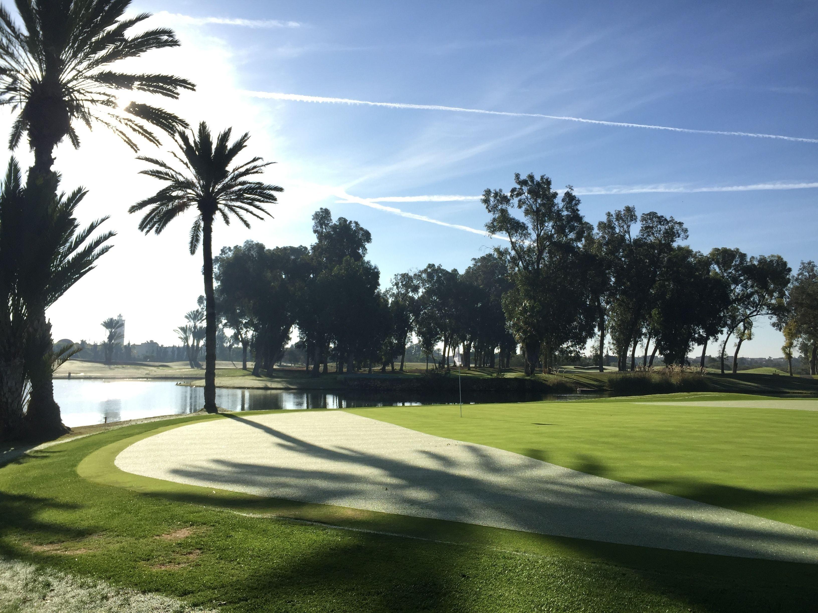 A well maintained fairway next to a water hazard at Tikida Golf Palace