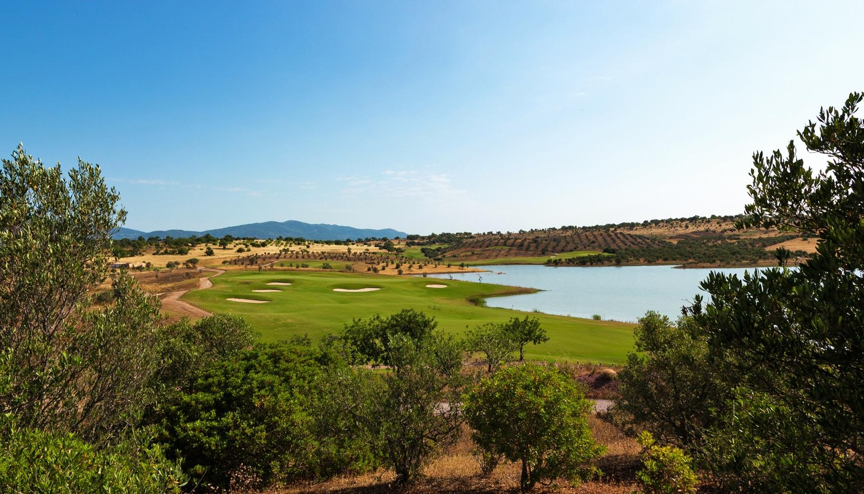 Overhead view of a well maintained fairway nestled with sand bunkers next to a water hazard