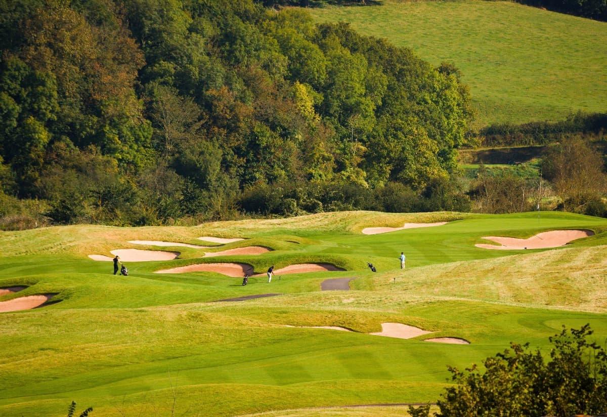 Panoramic view of well maintained fairway nestled with sand bunkers