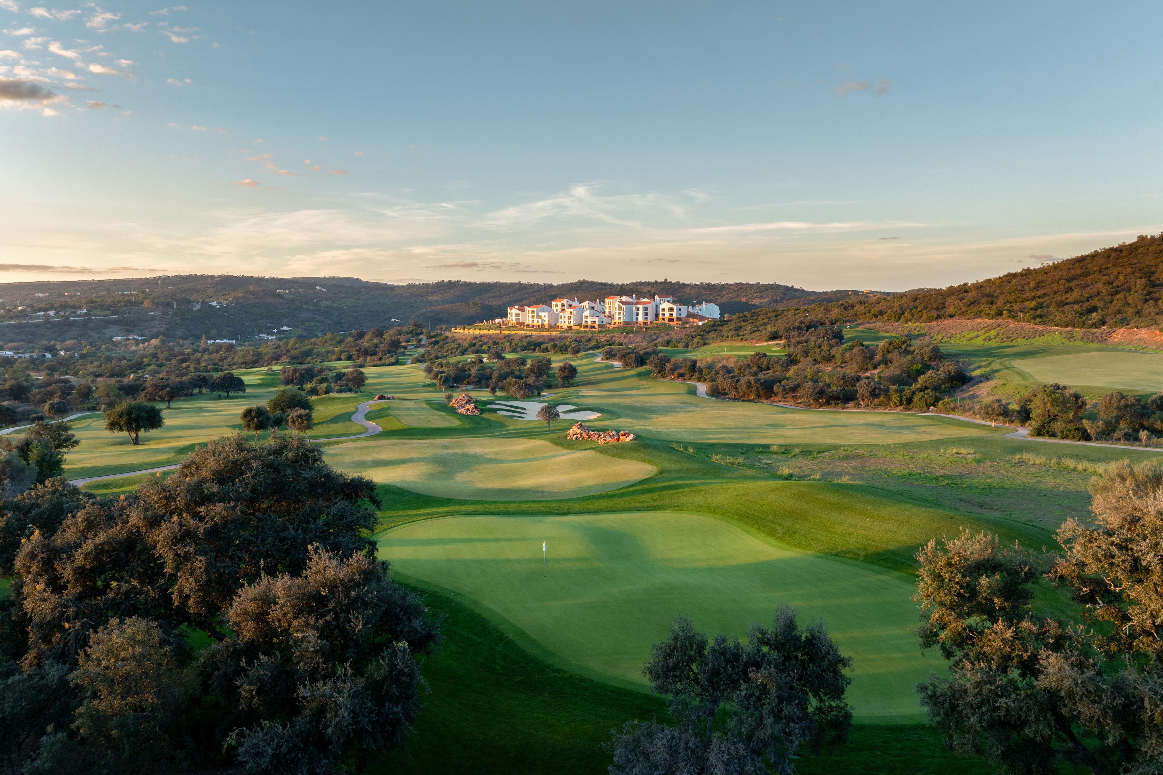 A well maintained fairway leading to a smooth green
