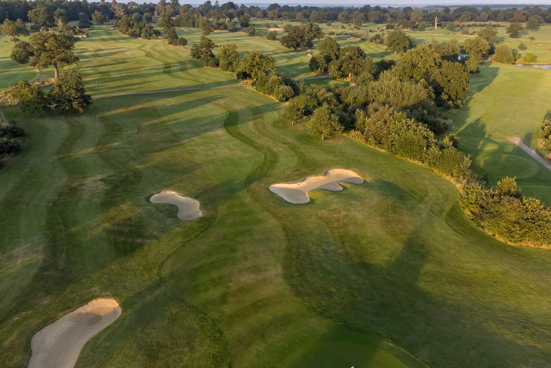 Overhead view of a well maintained fairway nestled with sand bunkers