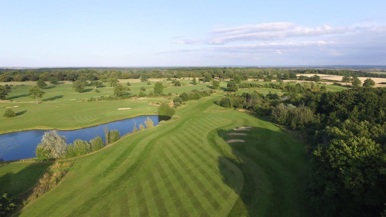 A well maintained fairway under blue skies
