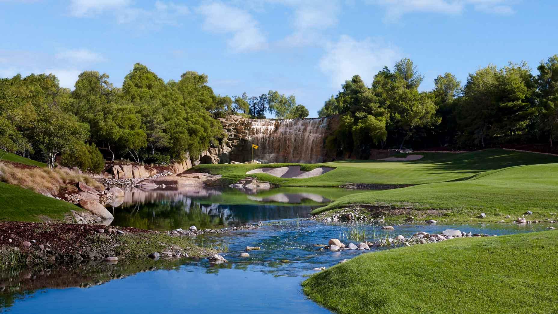 Panoramic view of a well maintained fairway next to a water hazard