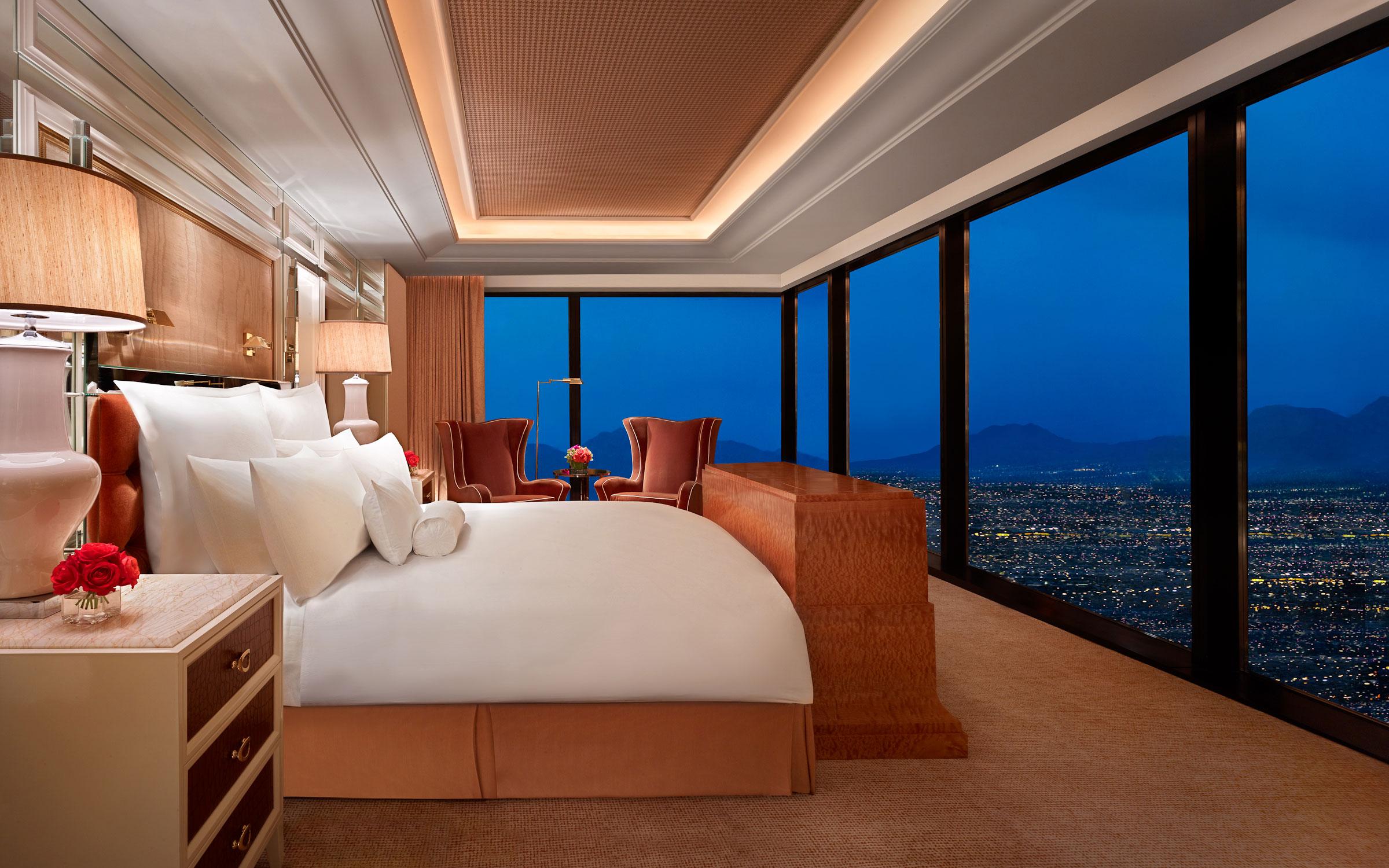 Double bed suite with panoramic window views of the city