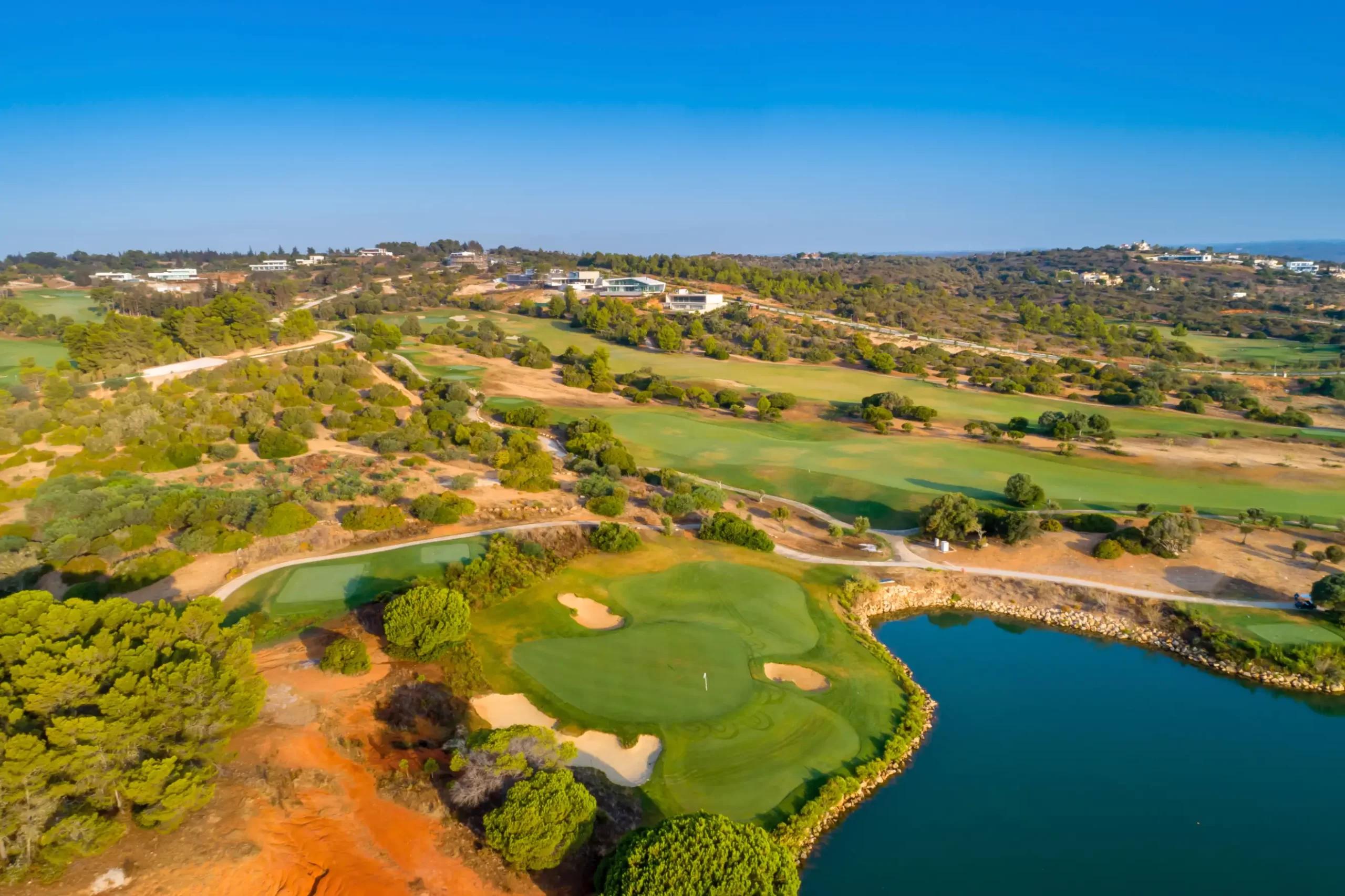 A well maintained green surrounded by sand bunkers