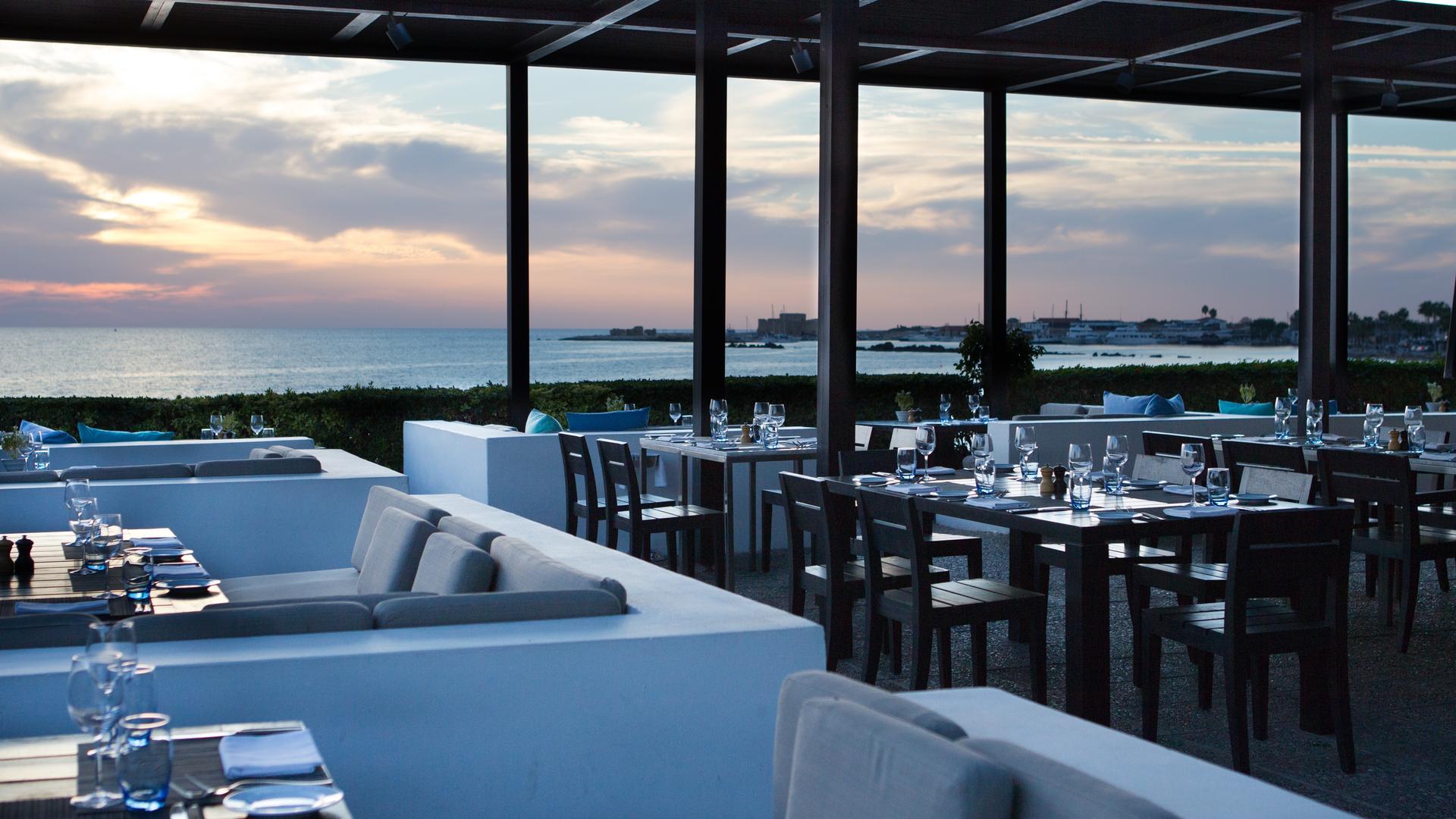 Outdoor dining area with ocean views at Almyra Hotel