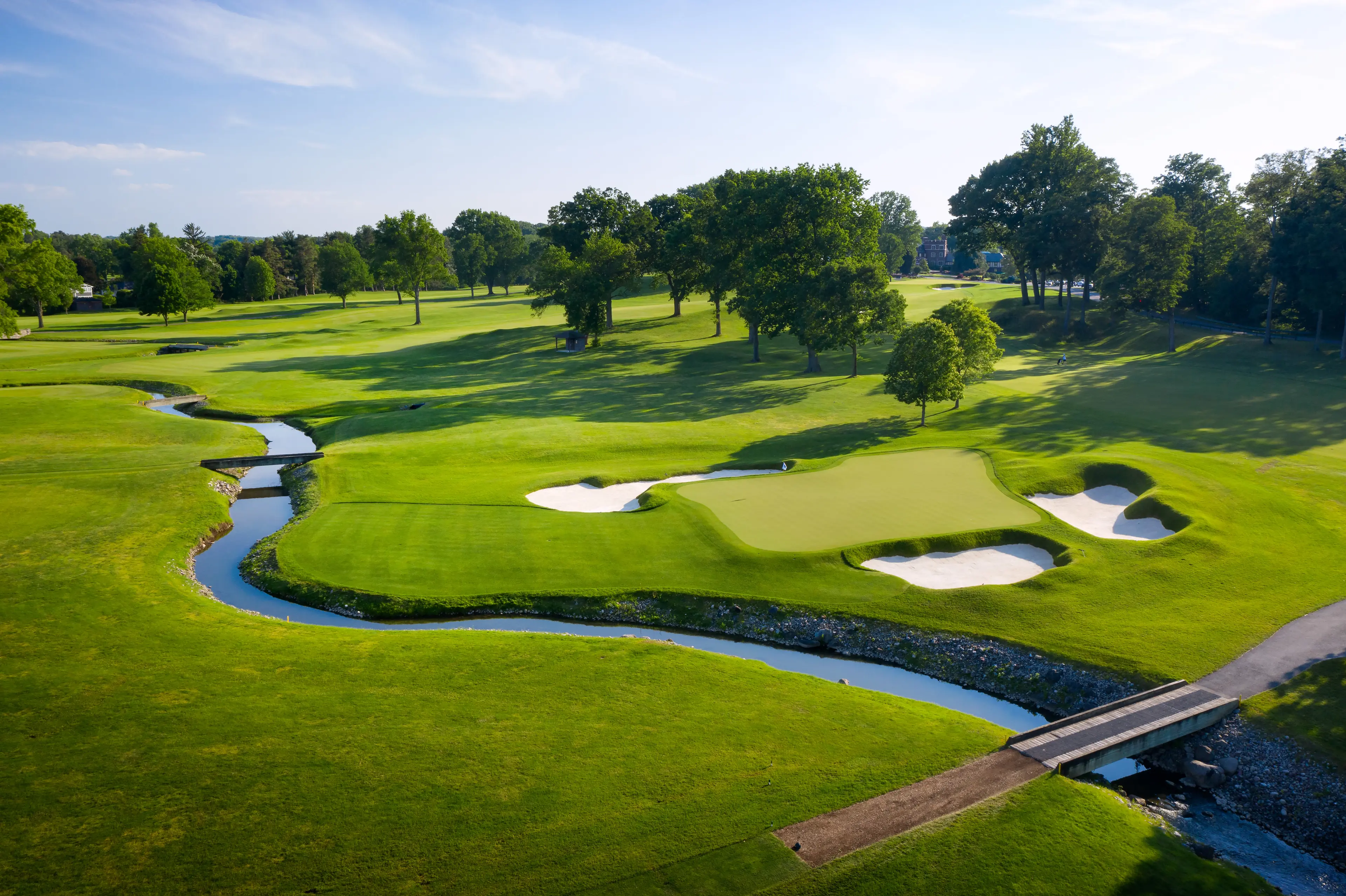 A well maintained fairway leading to a smooth green surrounded by sand bunkers