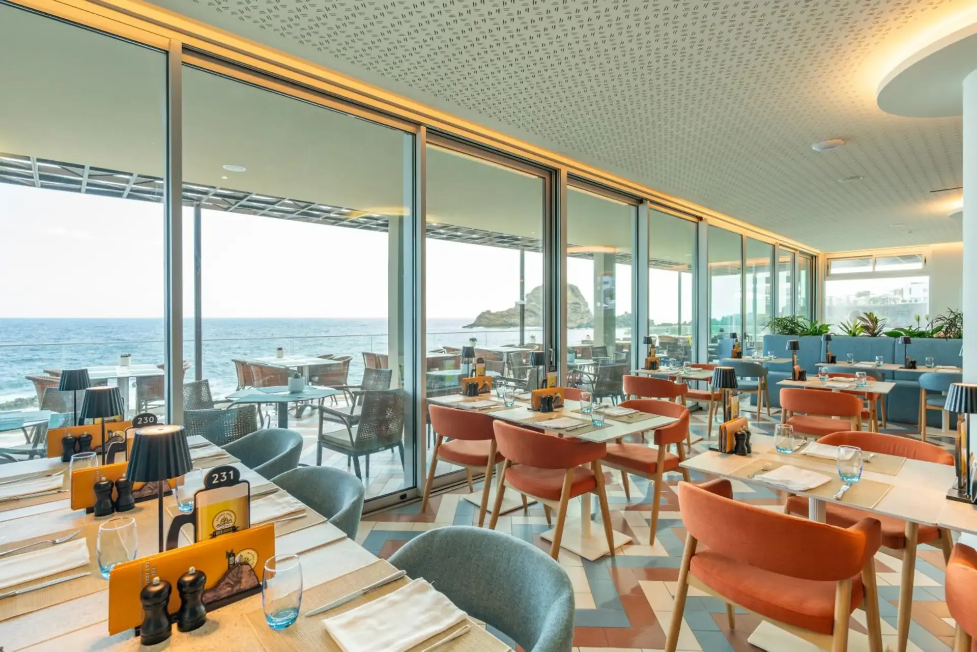 Indoor dining with coastal views at Aqua Natura Bay