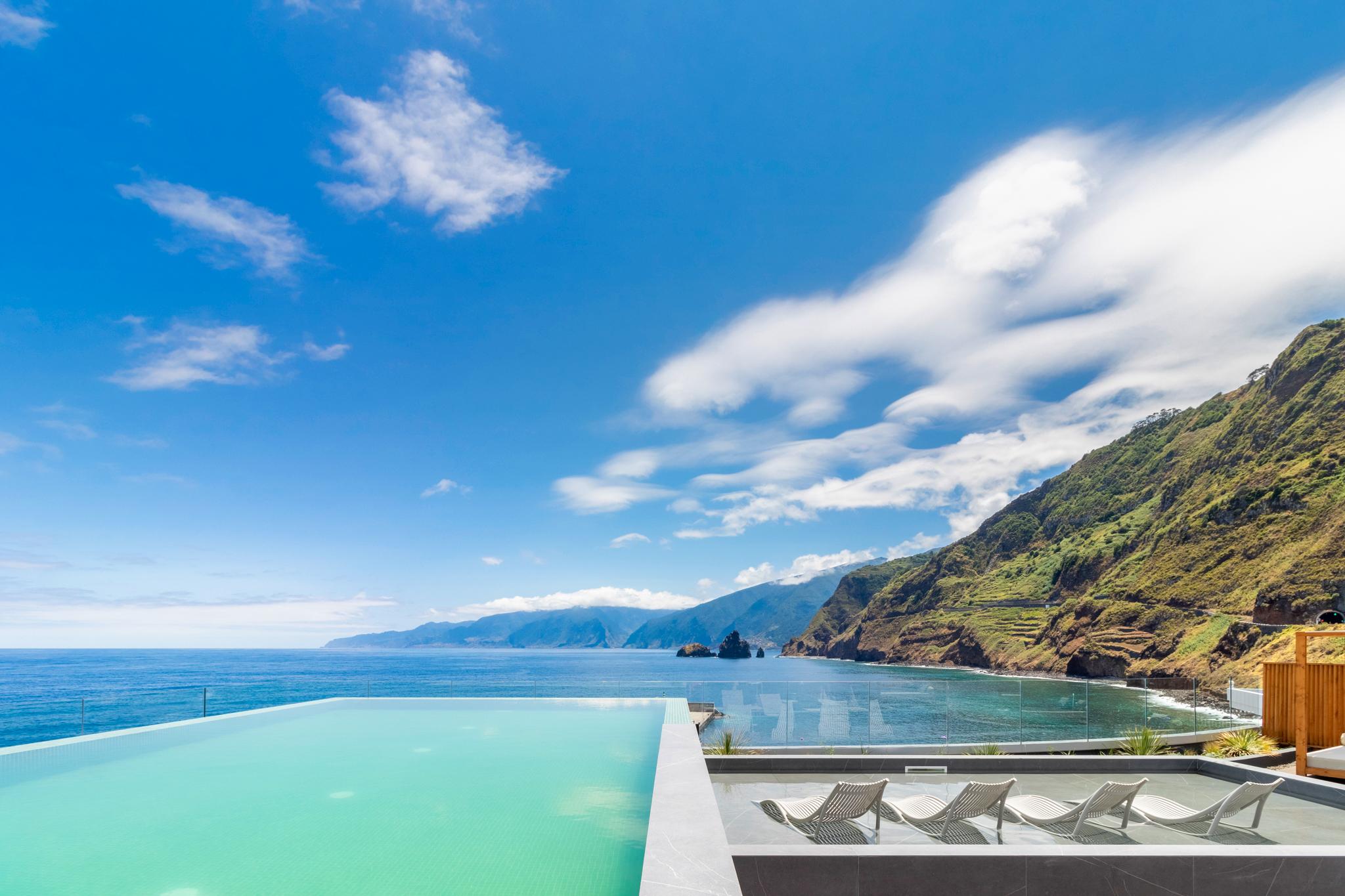 Outdoor swimming pool with mountain and ocean views at Aqua Natura Bay