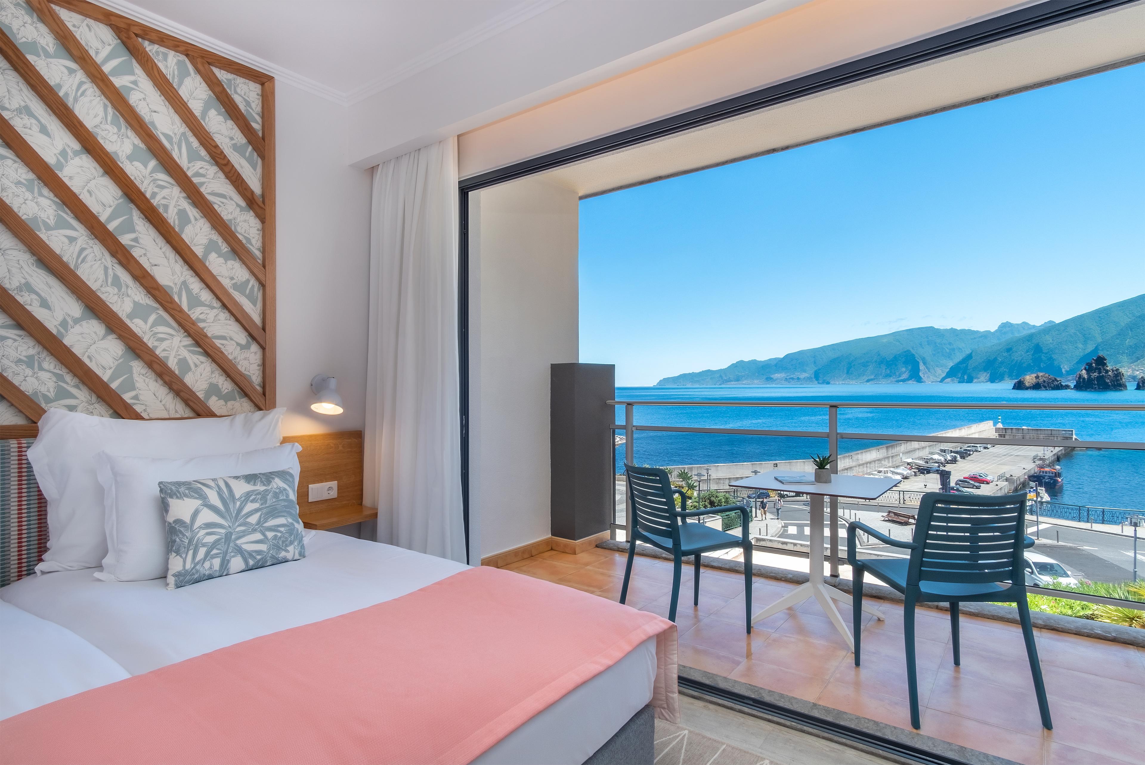 Double bed suite with balcony views of the coast at Aqua Natura Bay