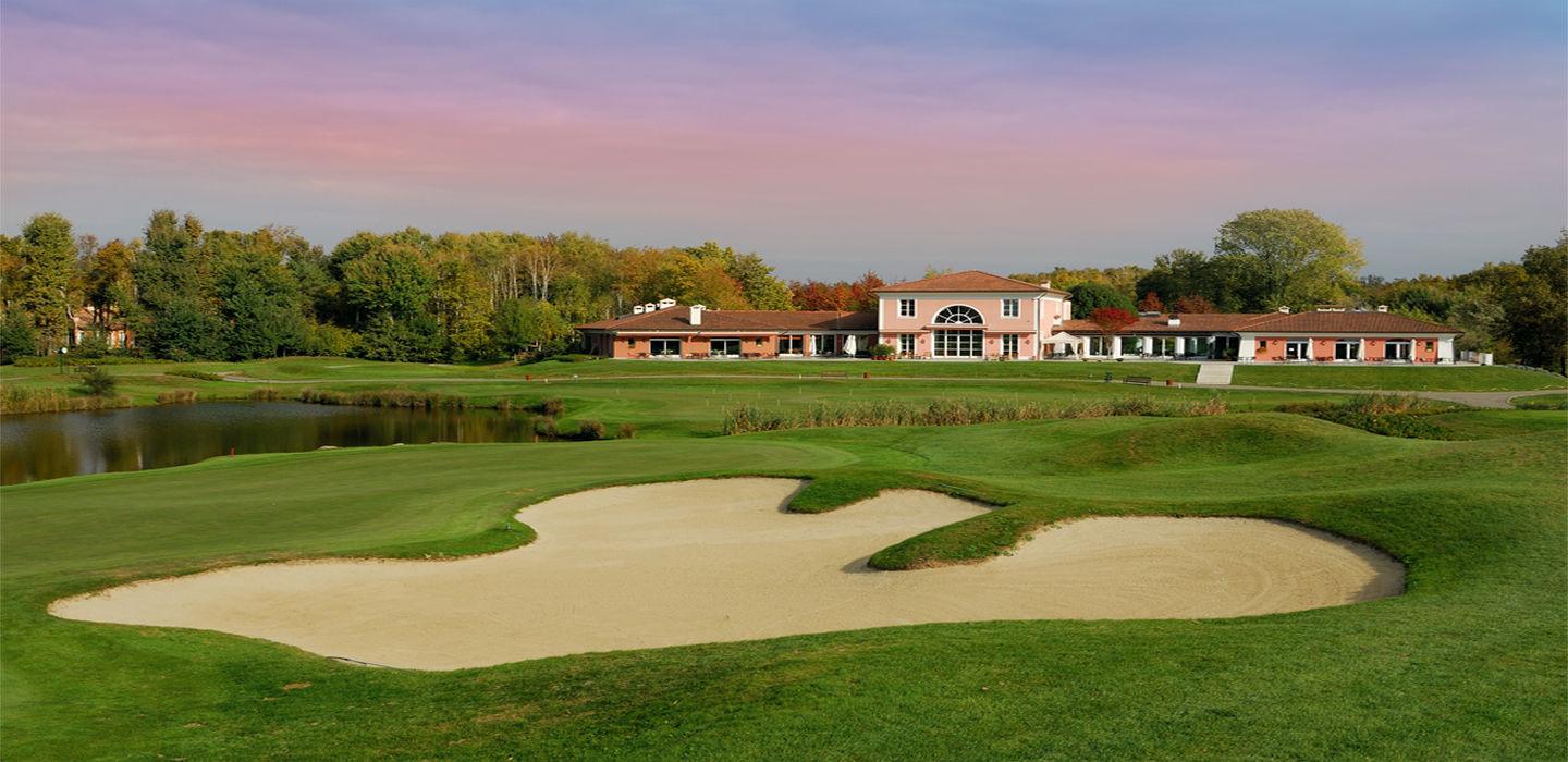 A large sand bunker on a well maintained fairway