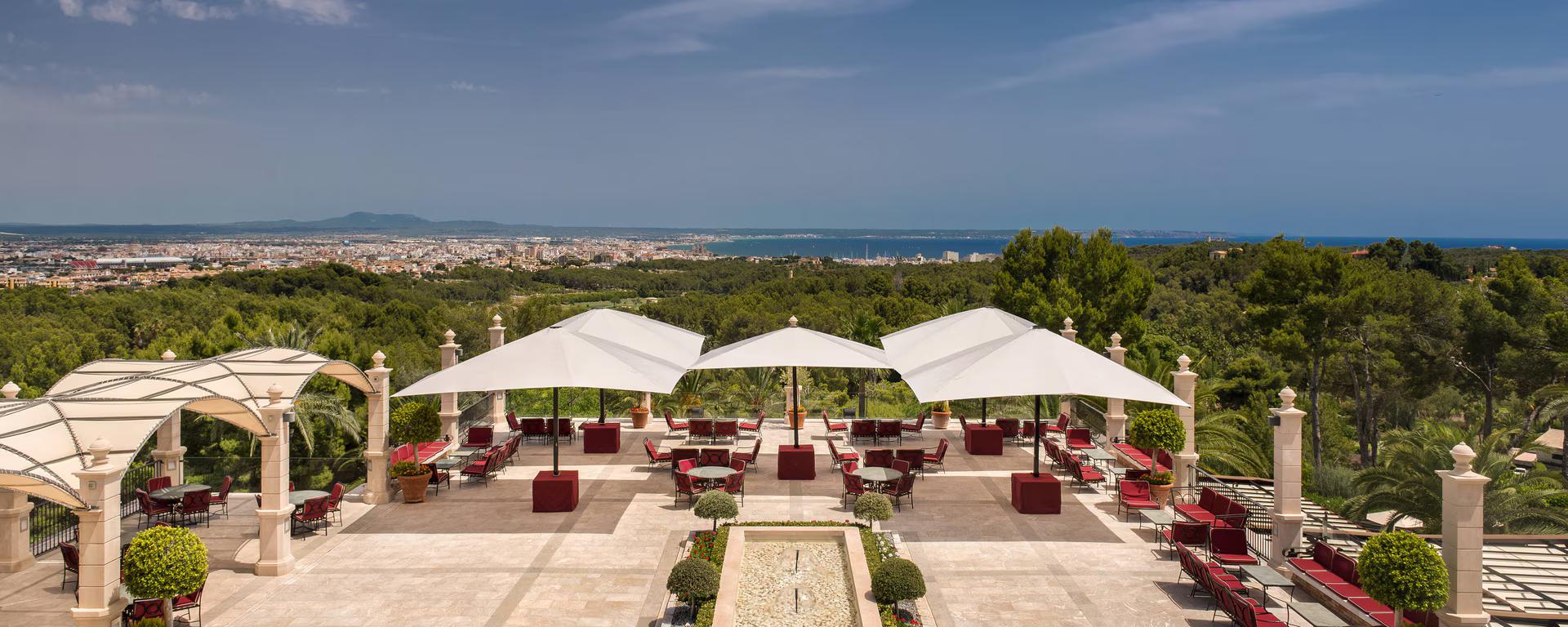 Outdoor lounging area with distant coastal views