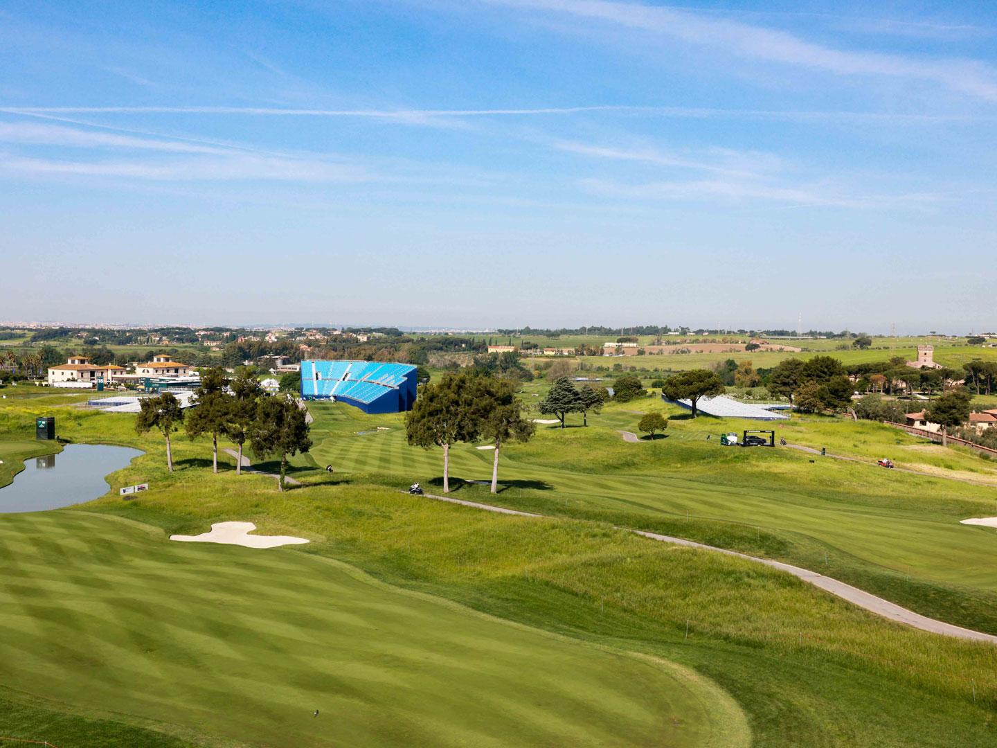 A well maintained green under clear blue skies at Marco Simone Golf